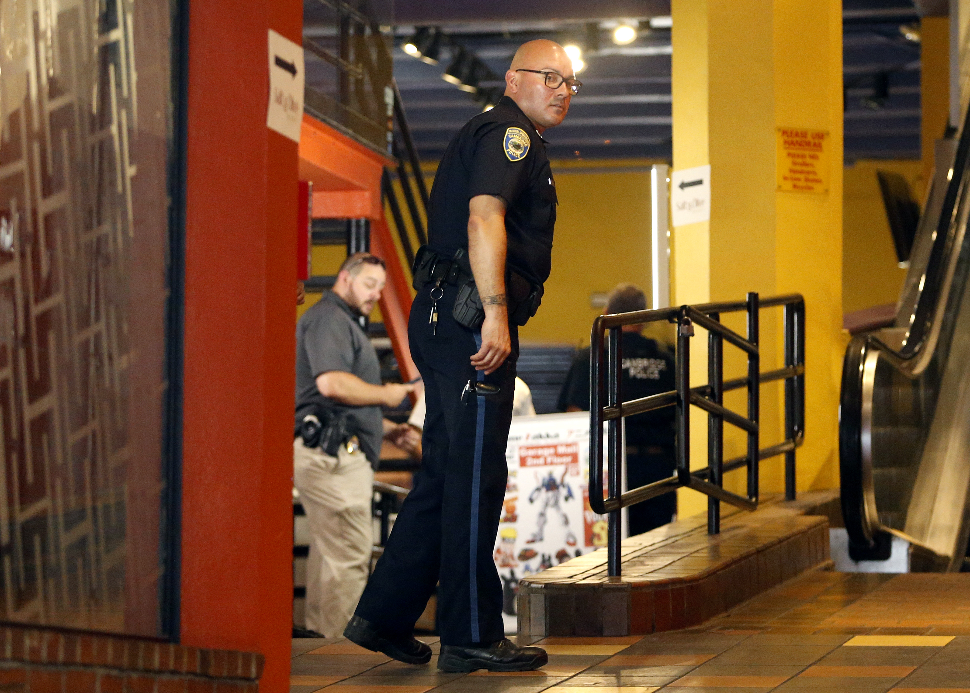 Law enforcement officials inside The Garage, where Ben & Jerry's is located in Harvard Square.