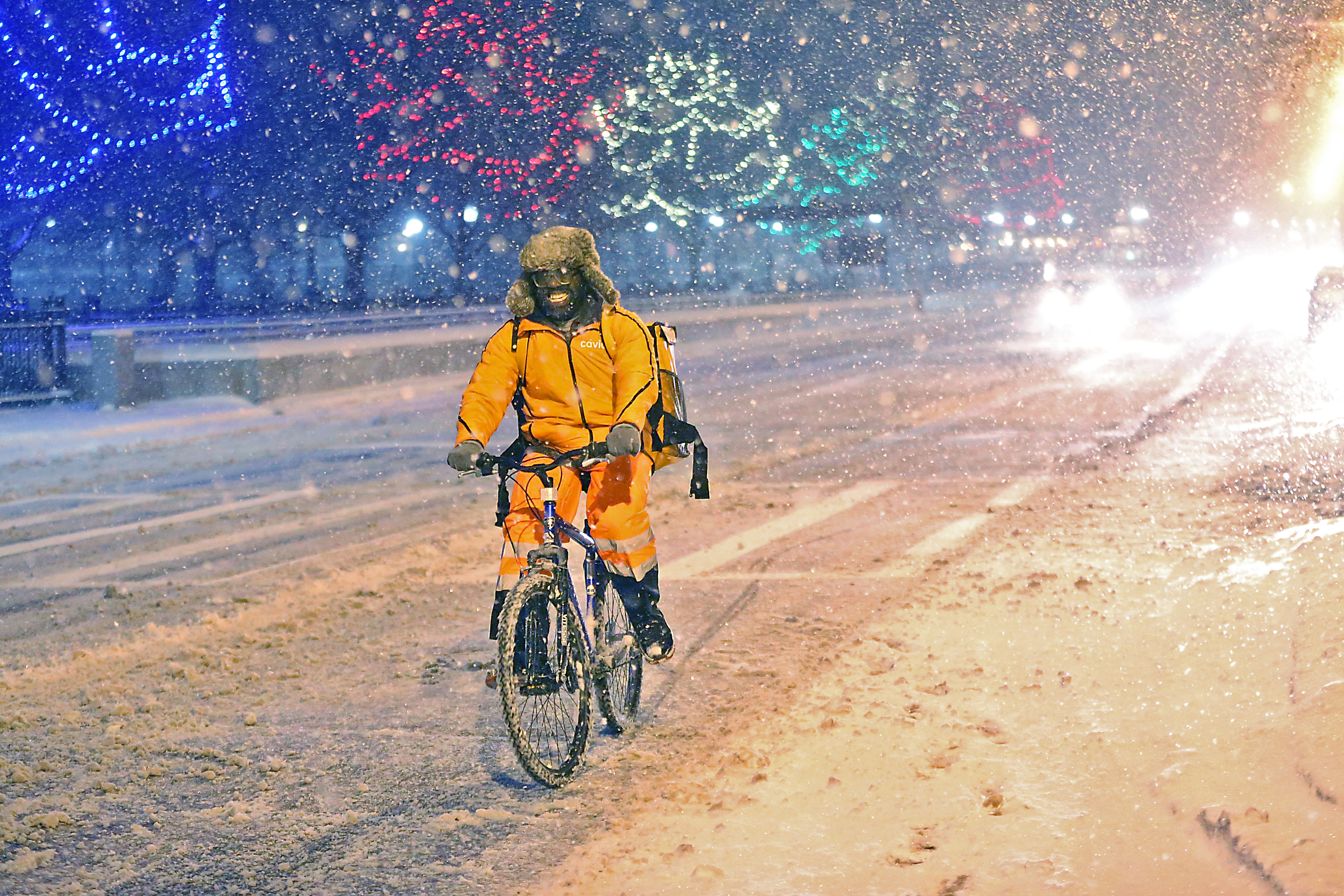 A food delivery rider bicycled on Charles Street during the storm.