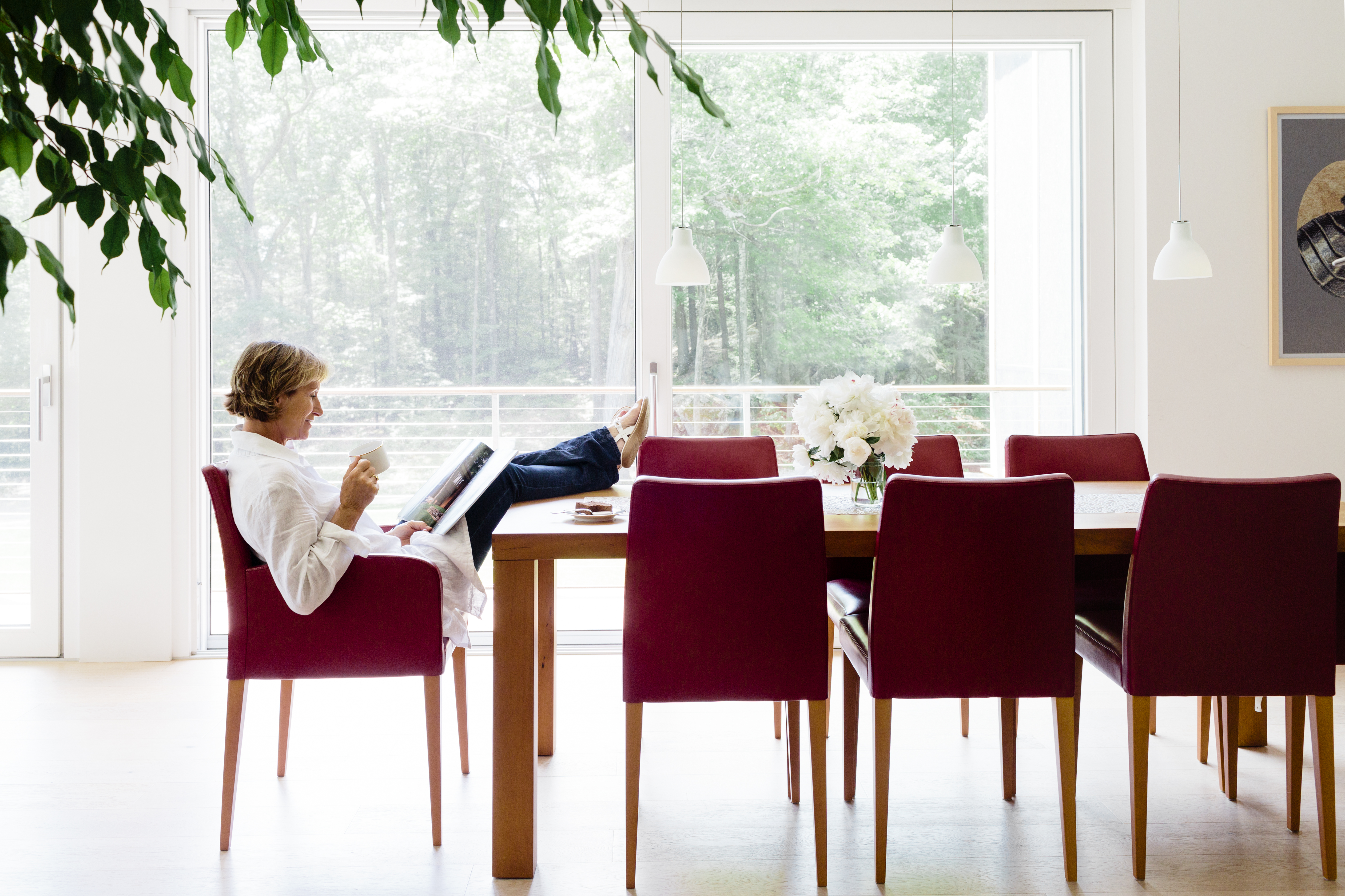 In Eva Fierst’s combined living, dining, and kitchen area, triple-glazed windows that flood the space with light can be opened to welcome summer breezes.