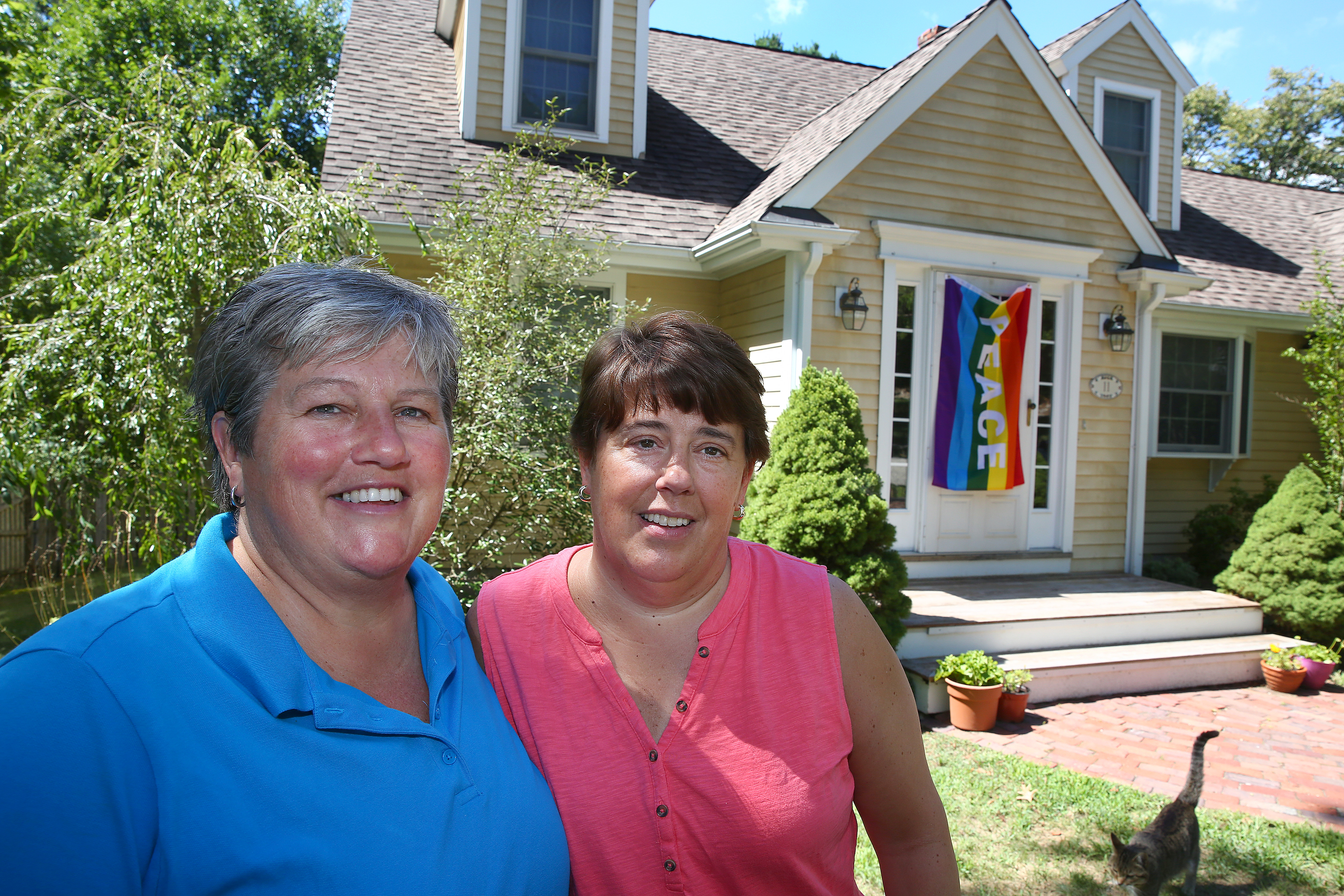 The Rydings at their house, with its new rainbow flag.