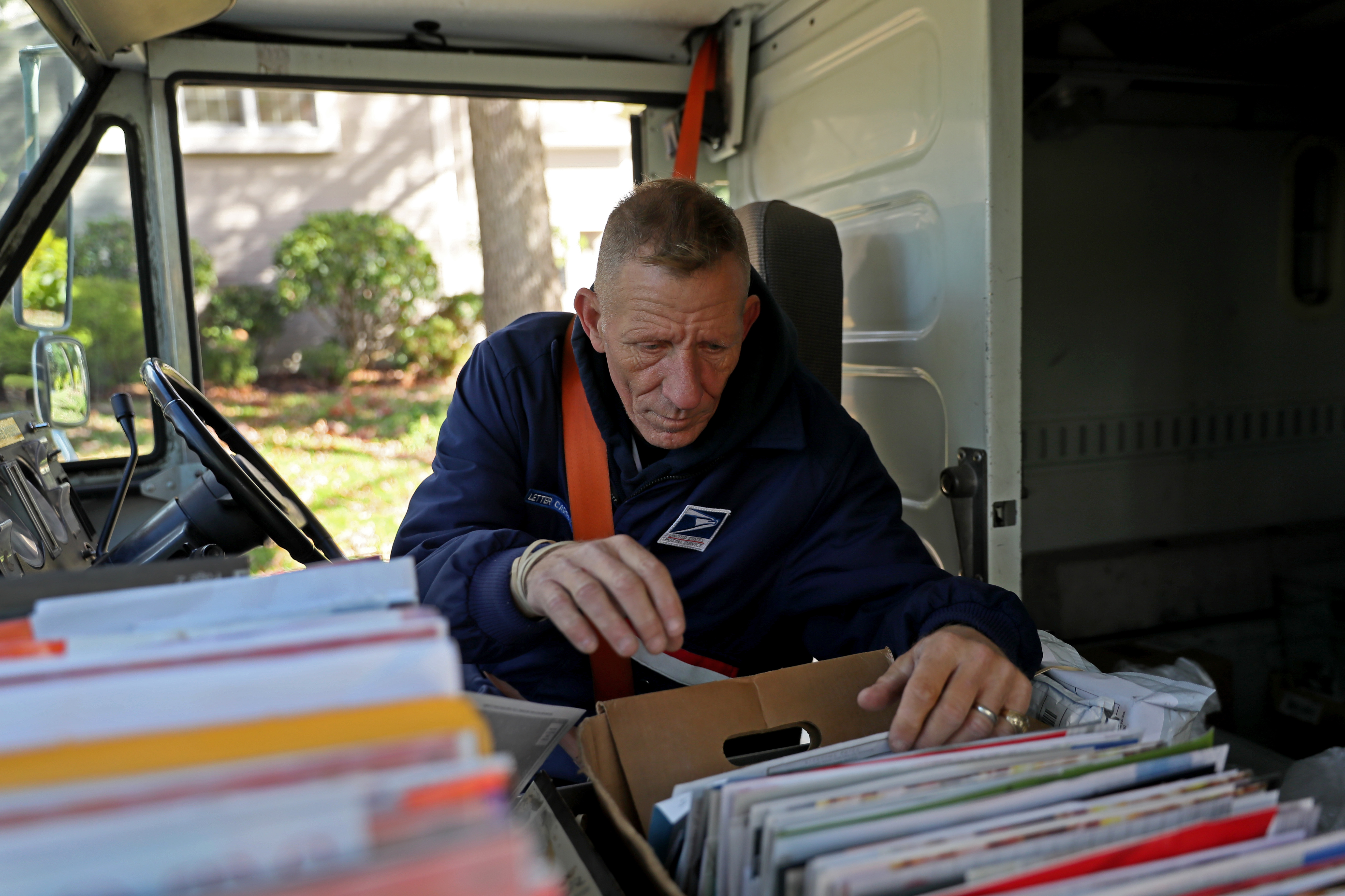Letter carrier Tom Ryan sorted mail in Wellesley. The Postal Service seeks 500 more workers in the region.