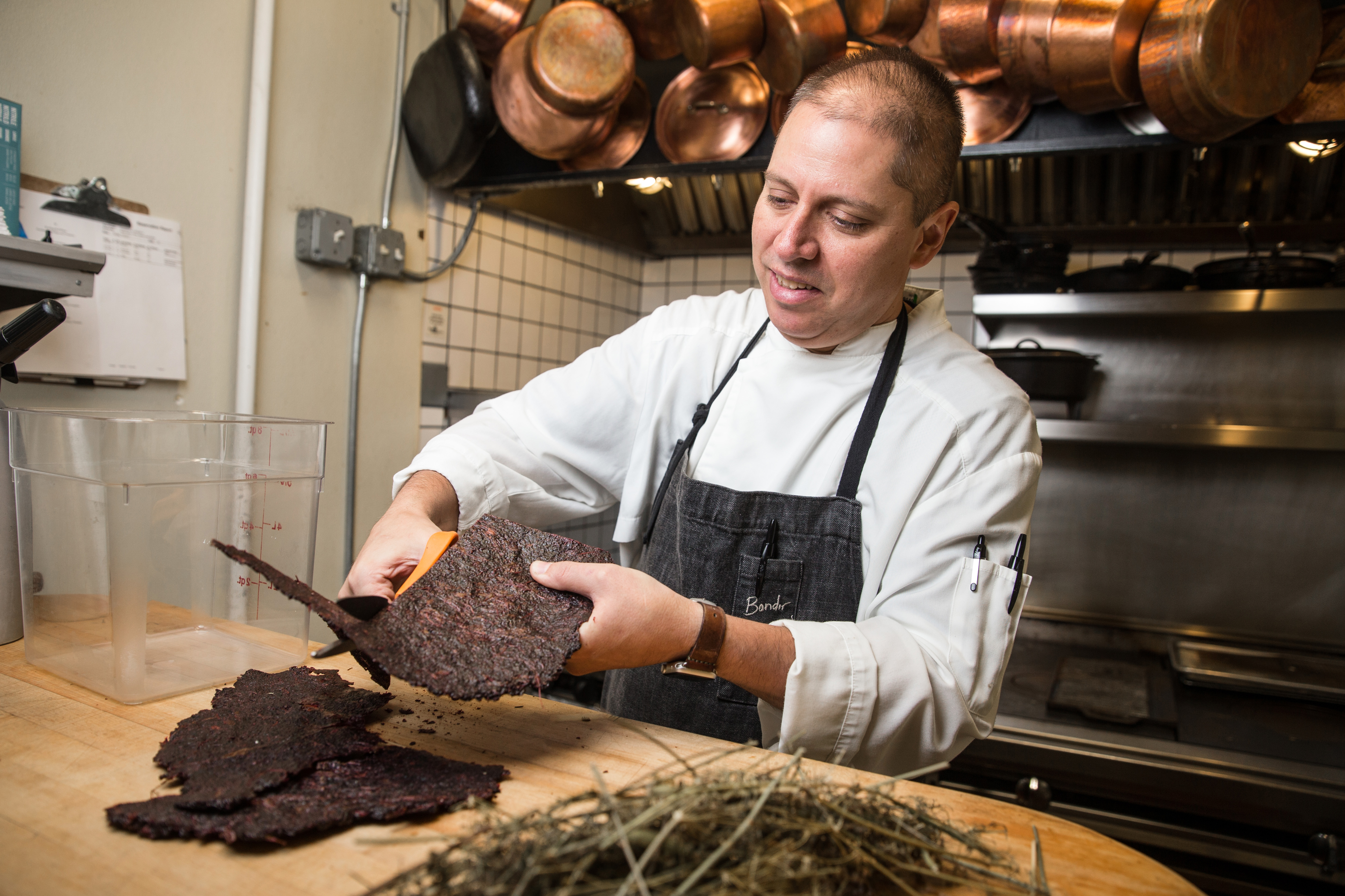 Bondir chef Jason Bond cuts up the dehydrated black currant scraps and fennel stalks in his Cambridge restaurant.