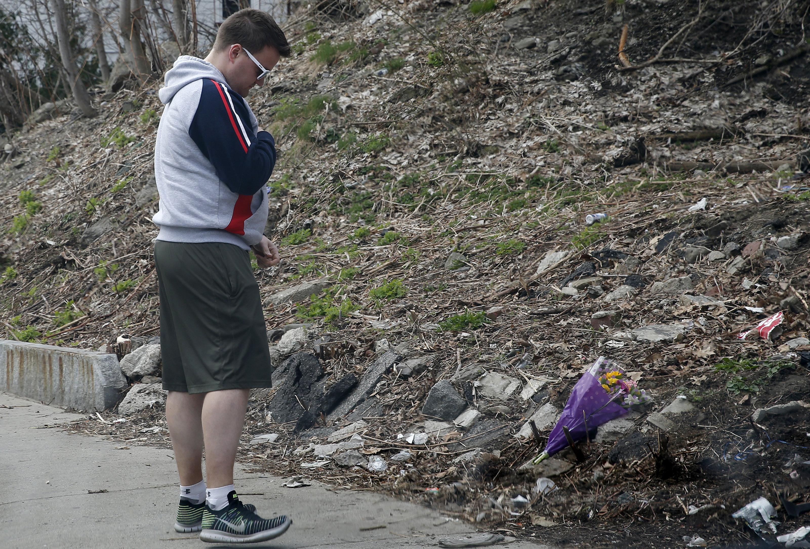 A man laid flowers at the scene where the body of Max Carbone was found.