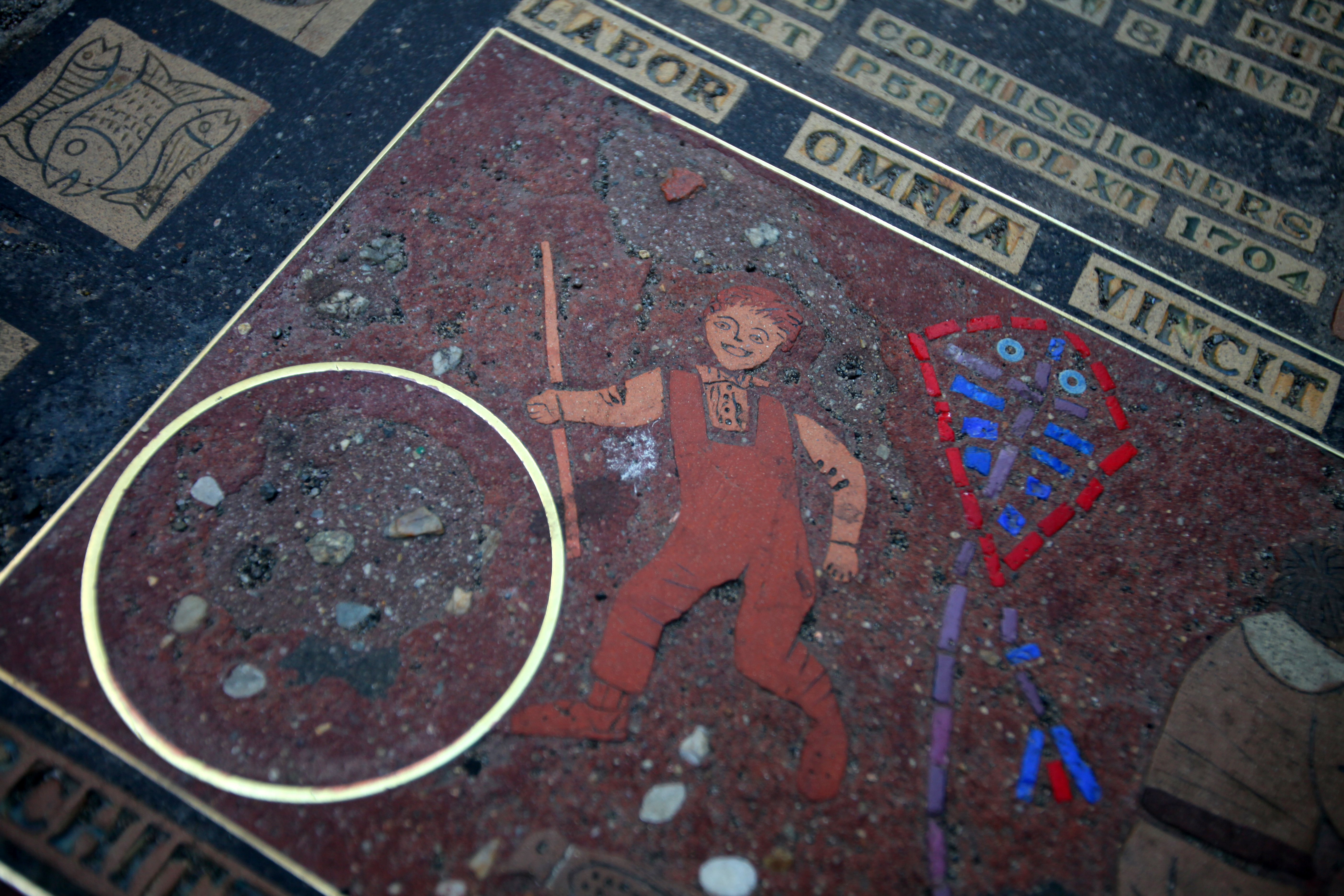 Lilli Ann Killen Rosenberg’s “City Carpet/Hopscotch” mosaic commemorates the establishment of Boston Latin School on the sidewalk at School Street.
