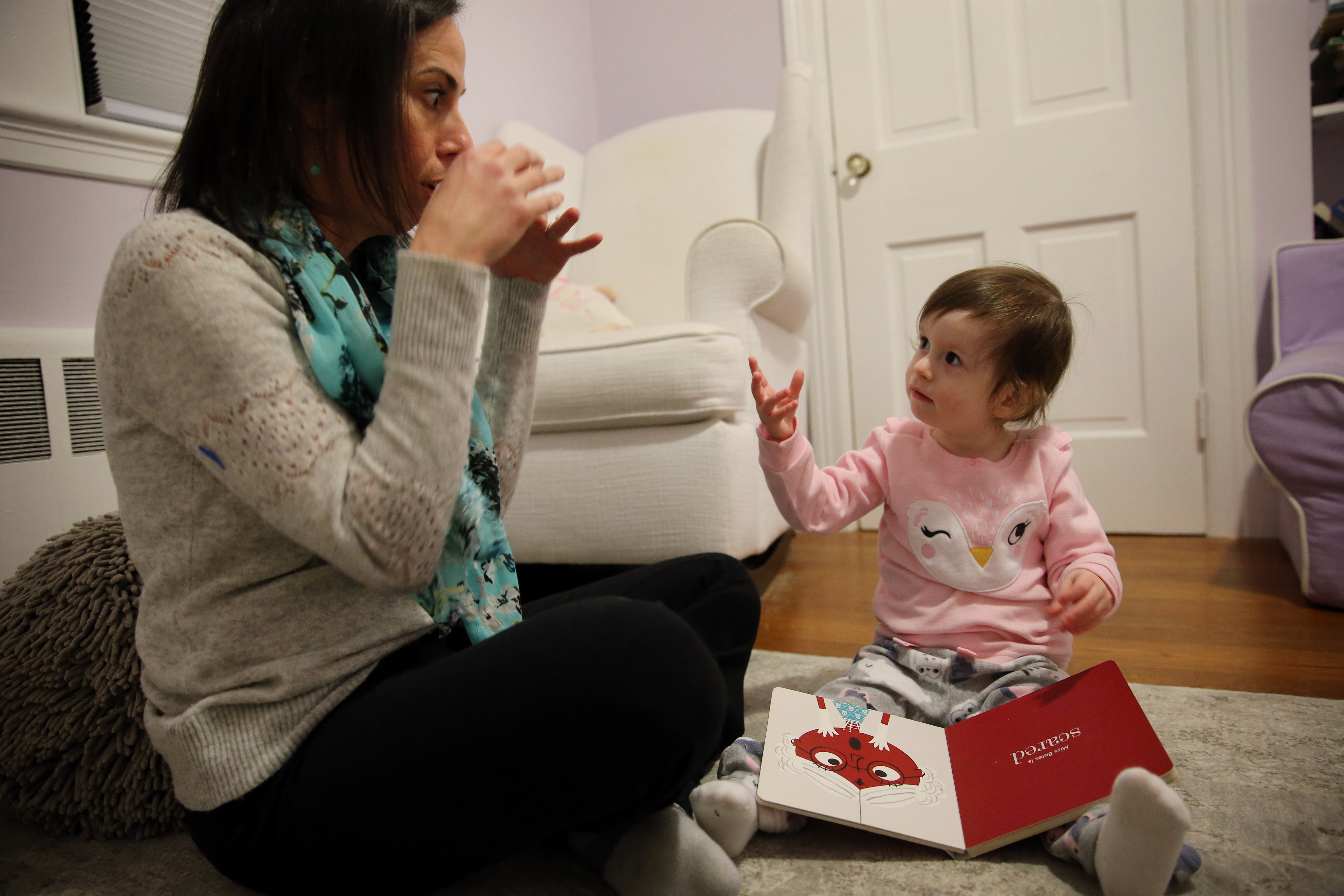 Glenda Savitz uses signs with her 2-year-old daughter, Samantha.