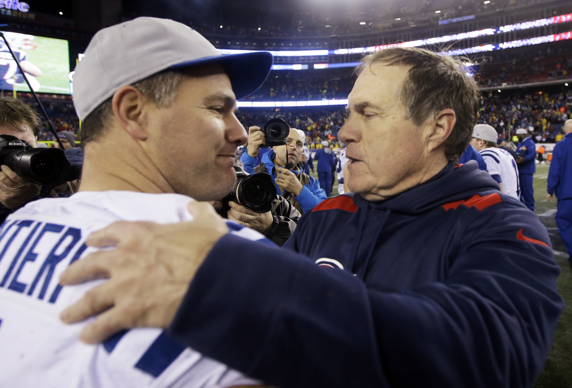 Former Patriots kicker Adam Vinatieri and coach Bill Belichick meet after the Patriots’ AFC Divisional round victory last season.