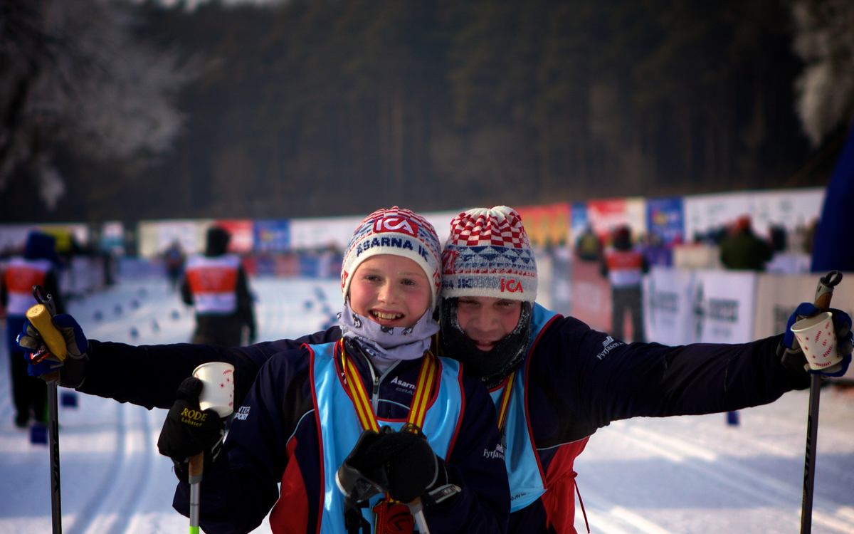 Rickard Aslund and son Matteus, from Sweden, celebrate their finish.