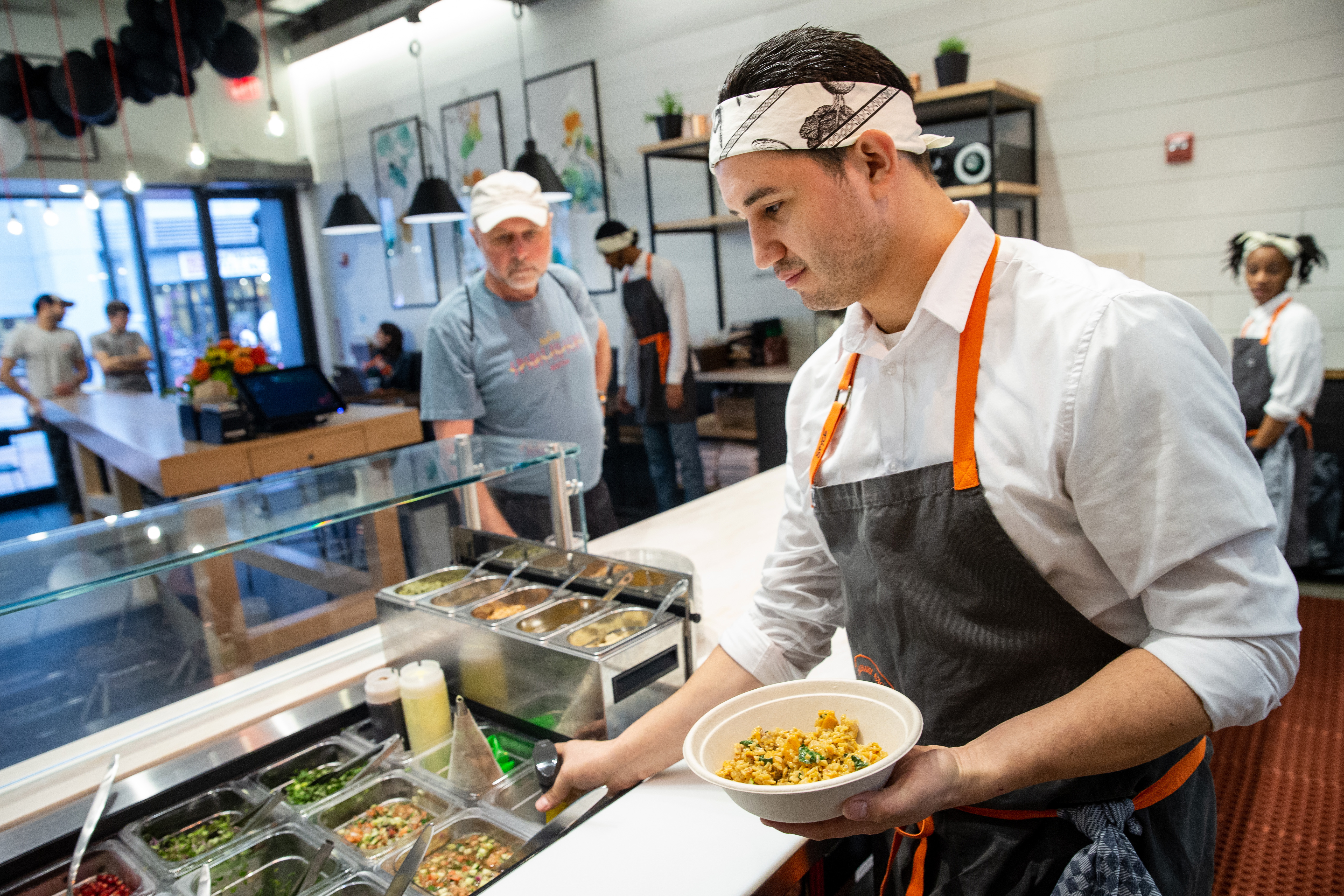 Chef garde manger Marcos Lemus adds the final details to a bowl at Spyce in Boston.