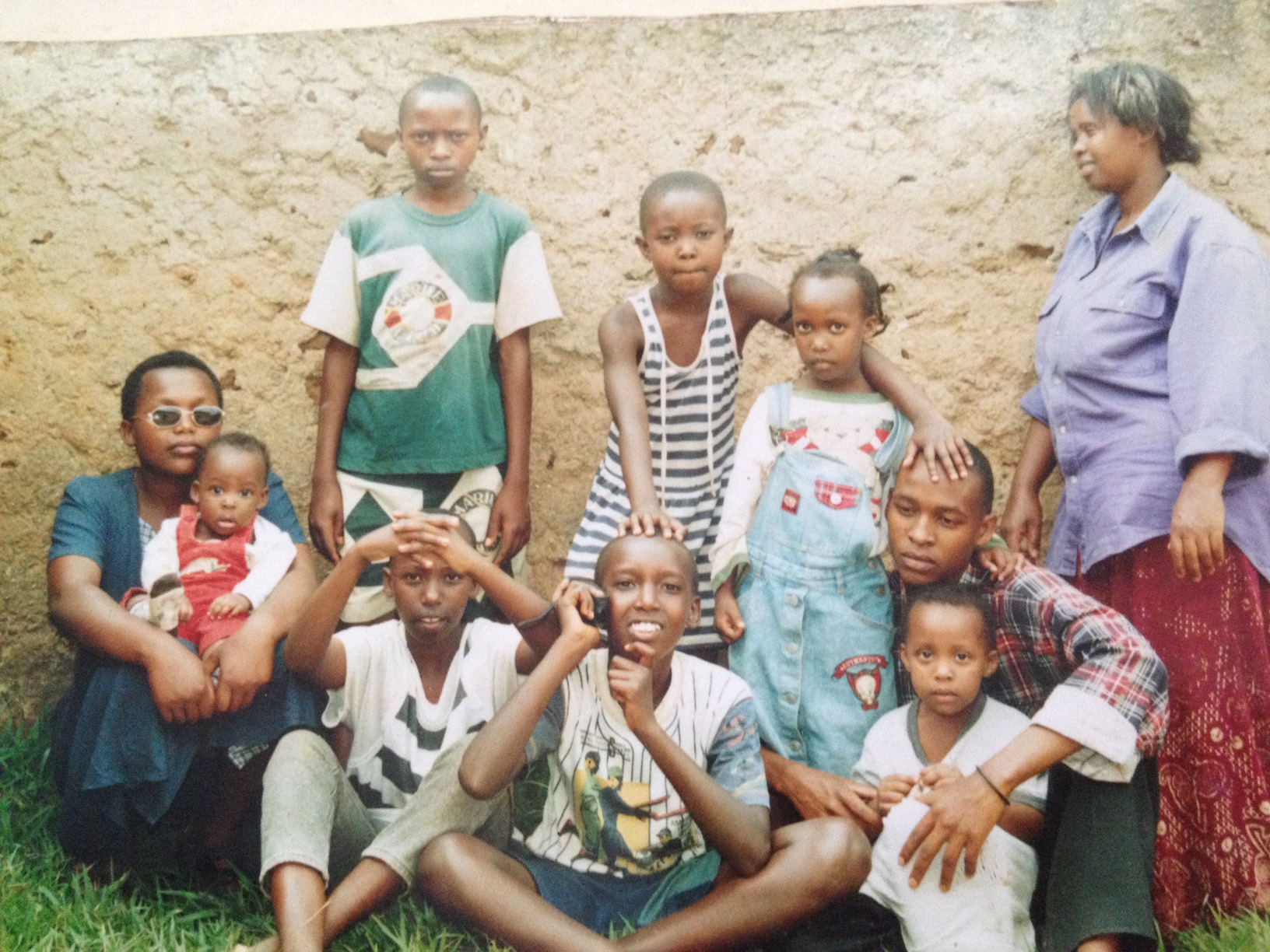Alex (front row, center) with relatives during a 2001 trip to Rwanda, where his mother lost nearly her entire family to genocide.
