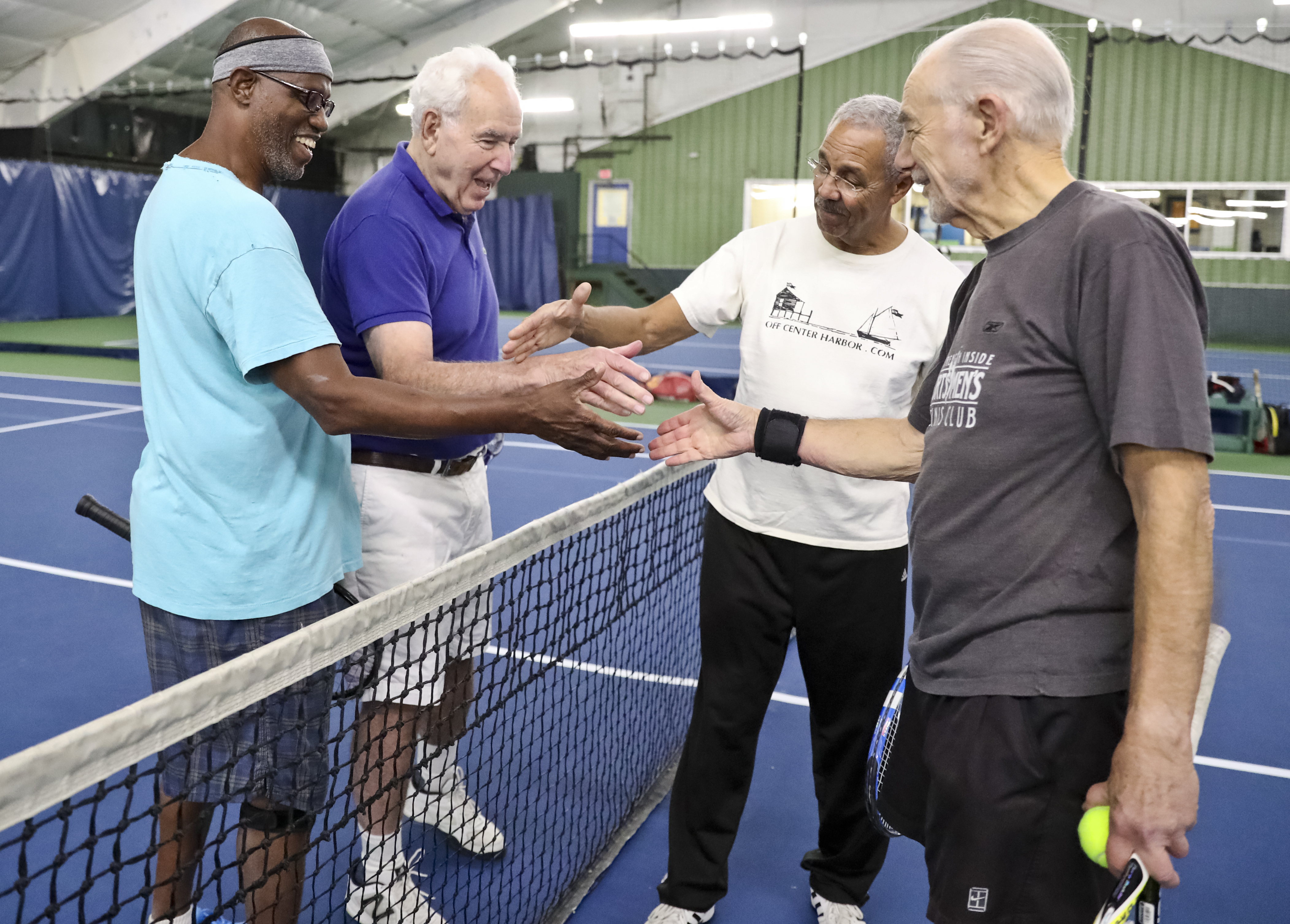 Selwyn Dyette, 65, Ray Green, 81, Robert Freeman, 71, and Bob Frank, 76, shook hands after doubles Tennis game at the Sportsmen’s Tennis & Enrichment Center.