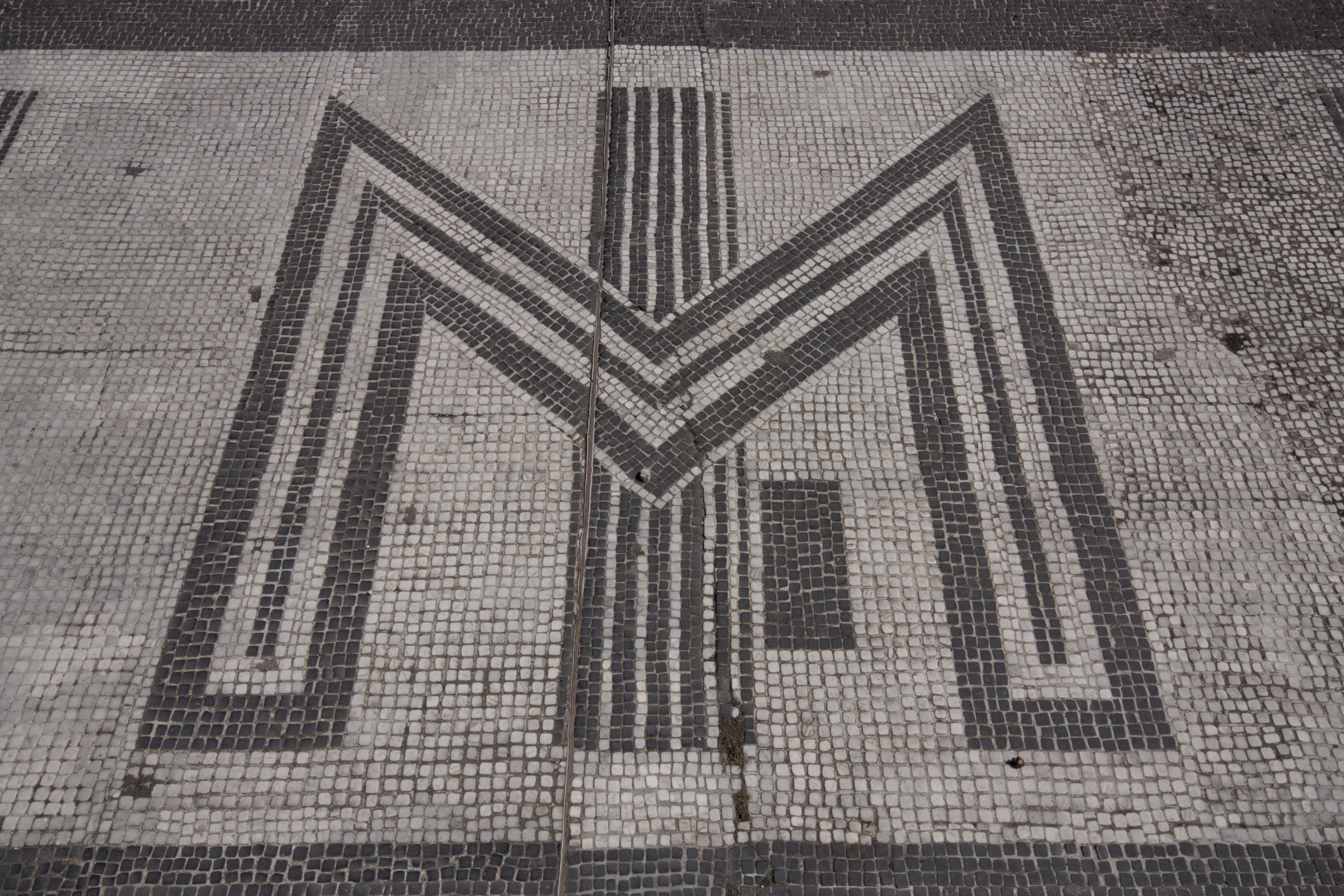 A monogram bisected by a stylized fasces.