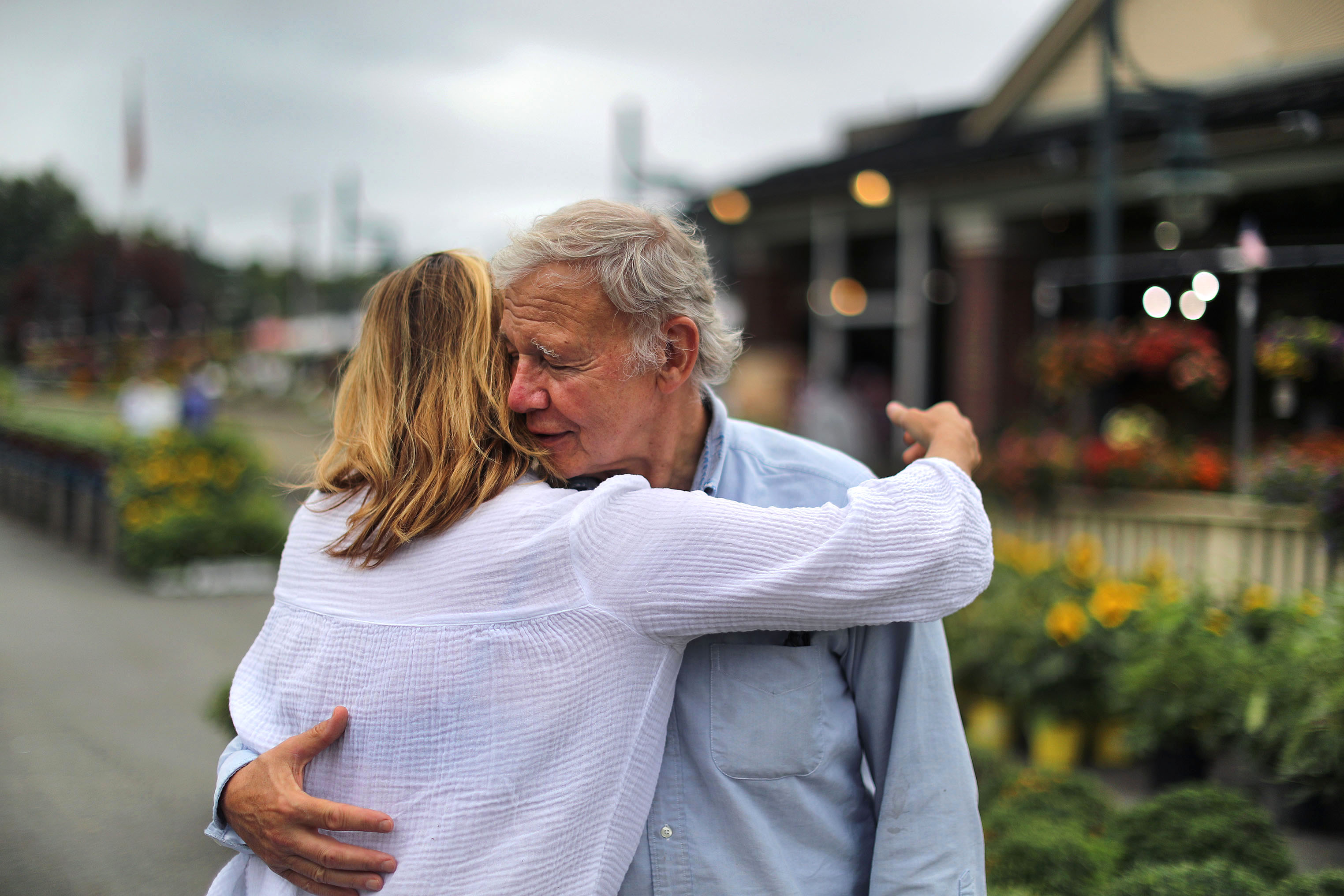 Karen Russo gives her father, Tony, a hug as she comes to give him a hand.