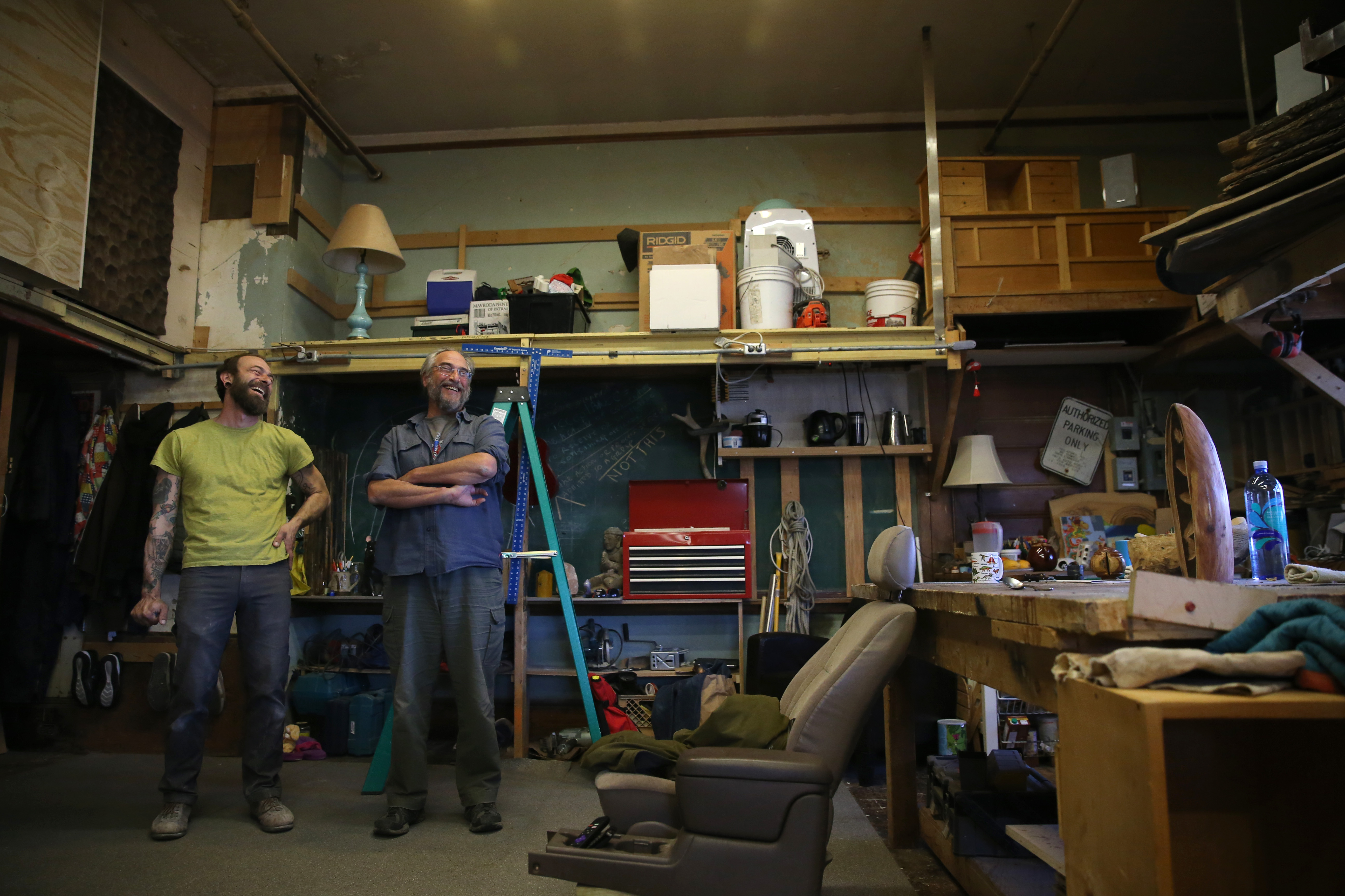 Tim Lorenzo (left) inherited his woodshop from Marc Rudnick (right). “The chair is out of my truck, and the chalkboards are from the original classrooms,” Lorenzo said.