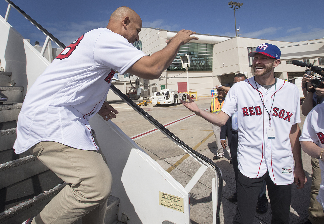 Alex Cora (left) is greeted by Chris Sale on their relief mission to Puerto Rico.