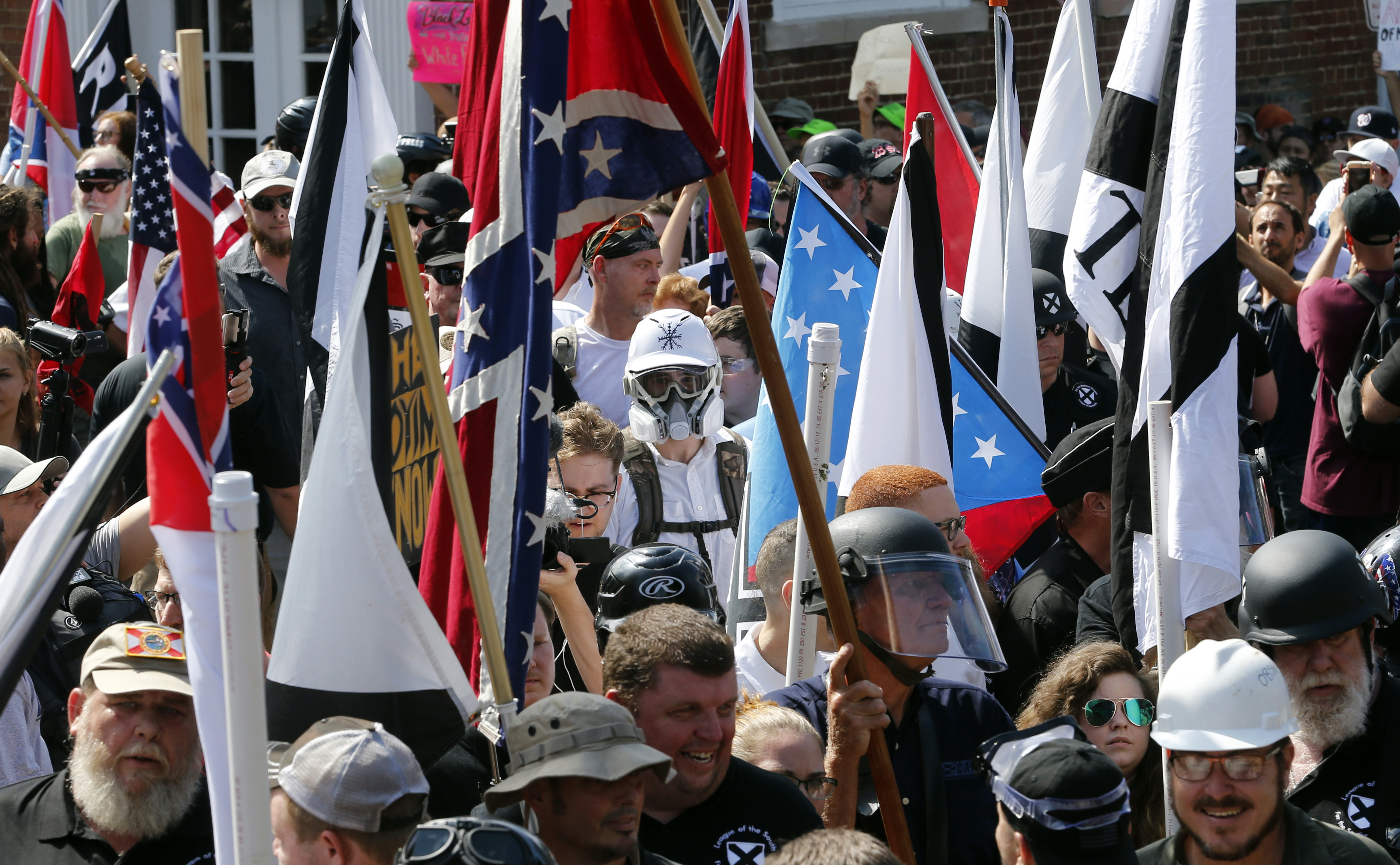 White nationalist demonstrators walked into the entrance of Lee Park surrounded by counter-demonstrators in Charlottesville, Va., on Aug. 12.