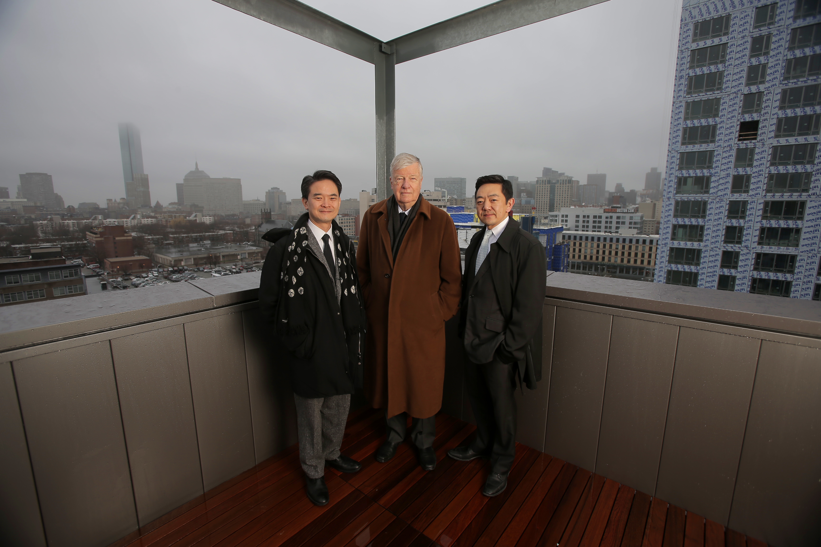 City planning director Kairos Shen, architect Henry Cobb, and developer Kelly Saito (from left, in a rooftop penthouse in one of Saito’s buildings) are altering the look of Boston.