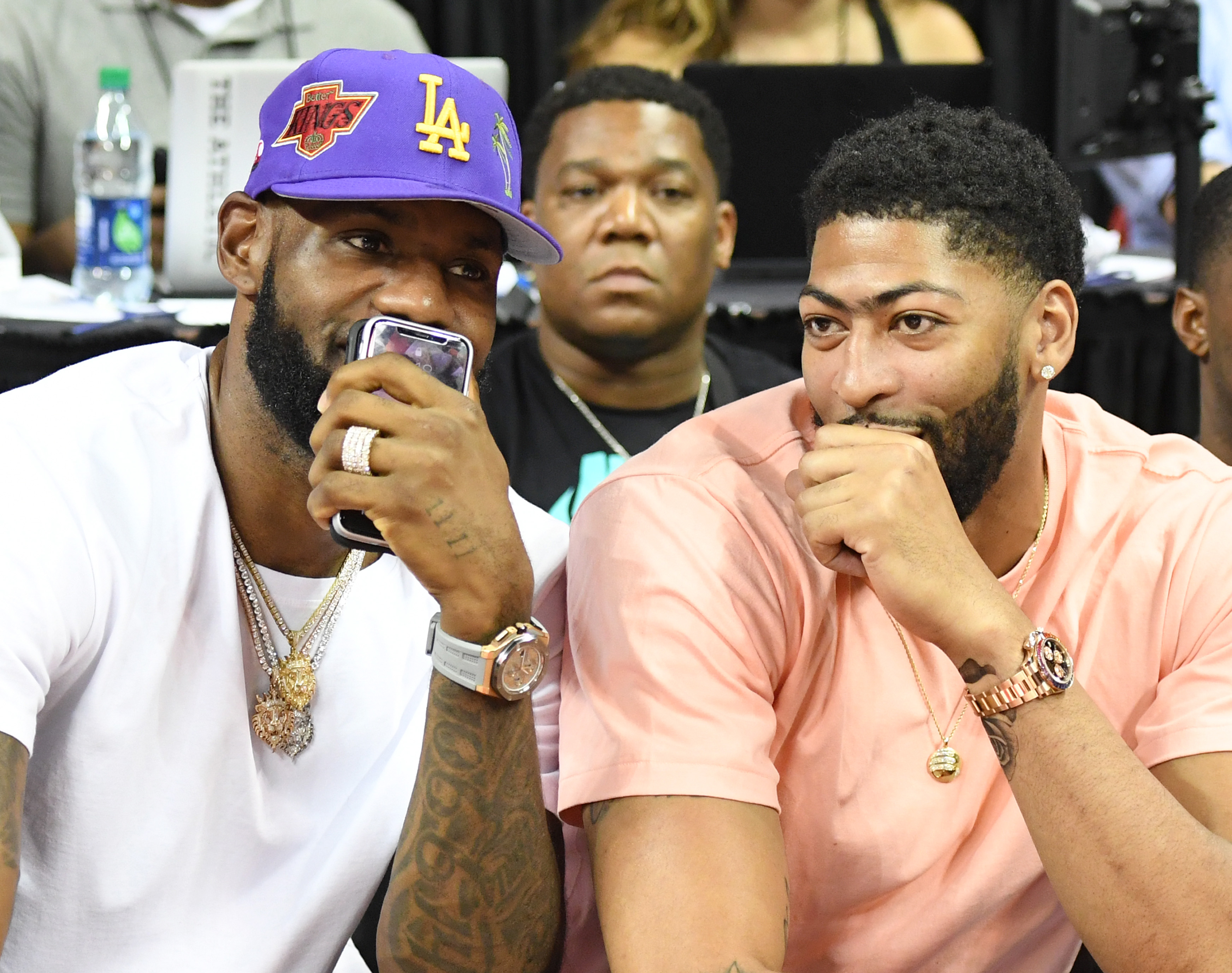 Lakers teammates LeBron James (left) and Anthony Davis talk as they watch the Pelicans play the Knicks in a Las Vegas Summer League game that featured the NBA debut of Zion Williamson.