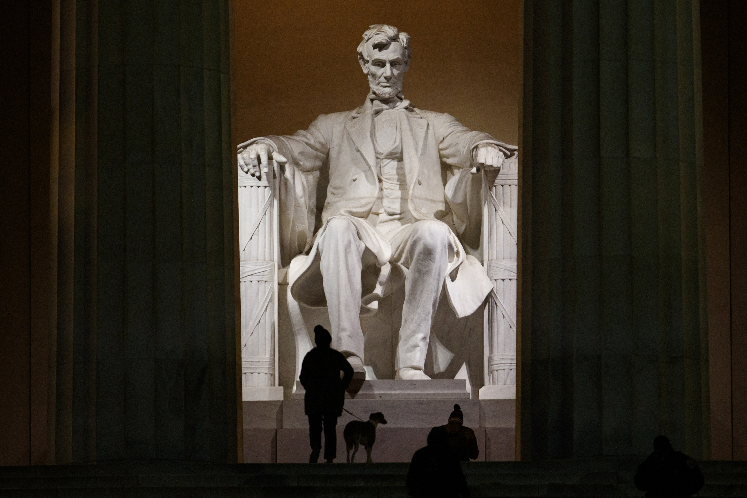 People climb the steps of the Lincoln Memorial before dawn in Washington.