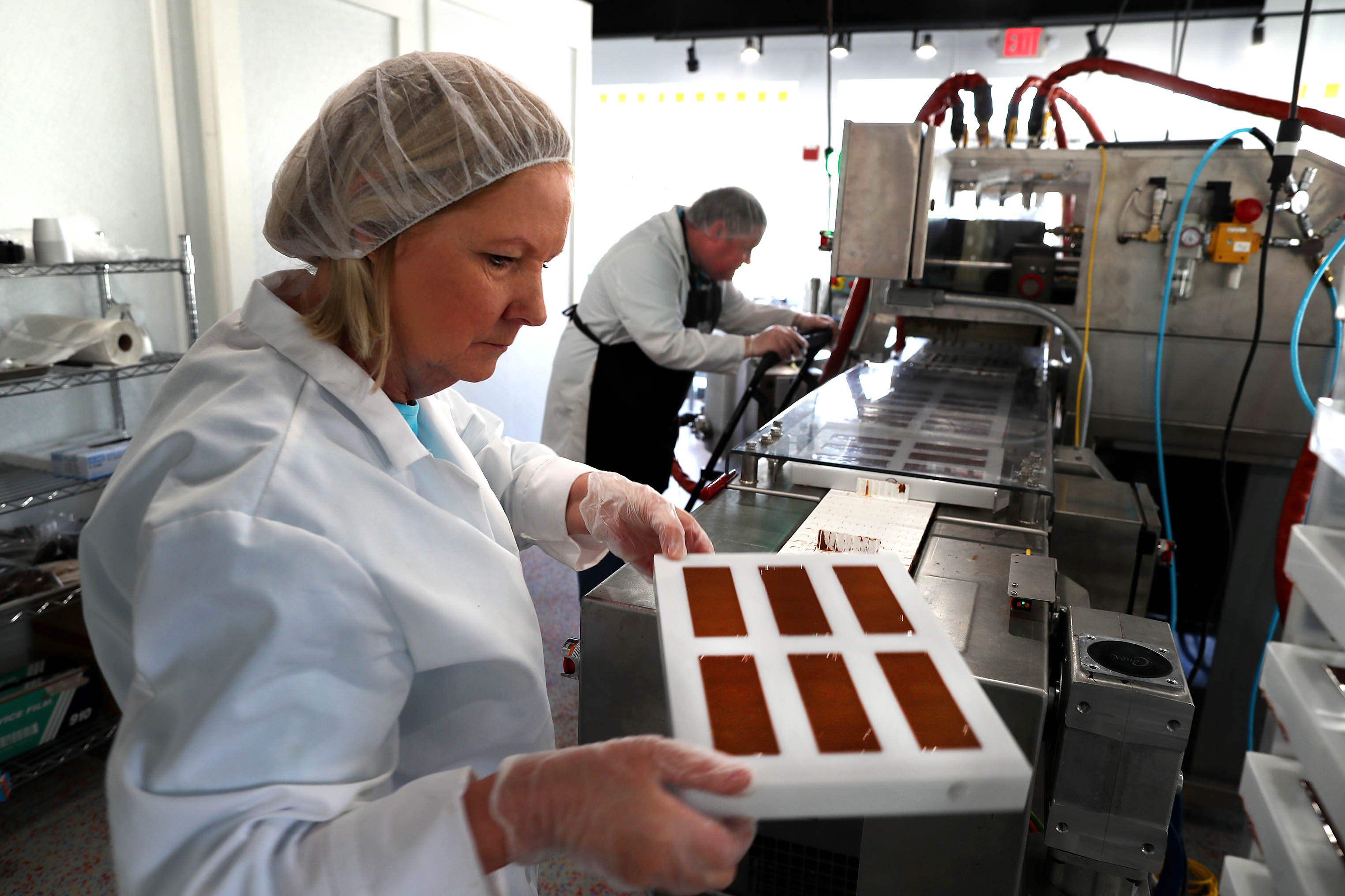 Louise Mawhinney and her son, Frank Mawhinney, make Sky Bars at their storefront location on Boston Post Road in Sudbury.