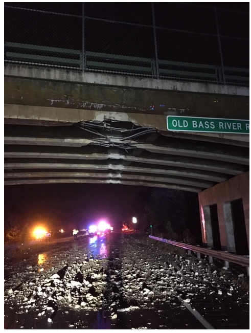 A view from beneath the bridge looking westbound down Route 6 shows the two damaged beams.