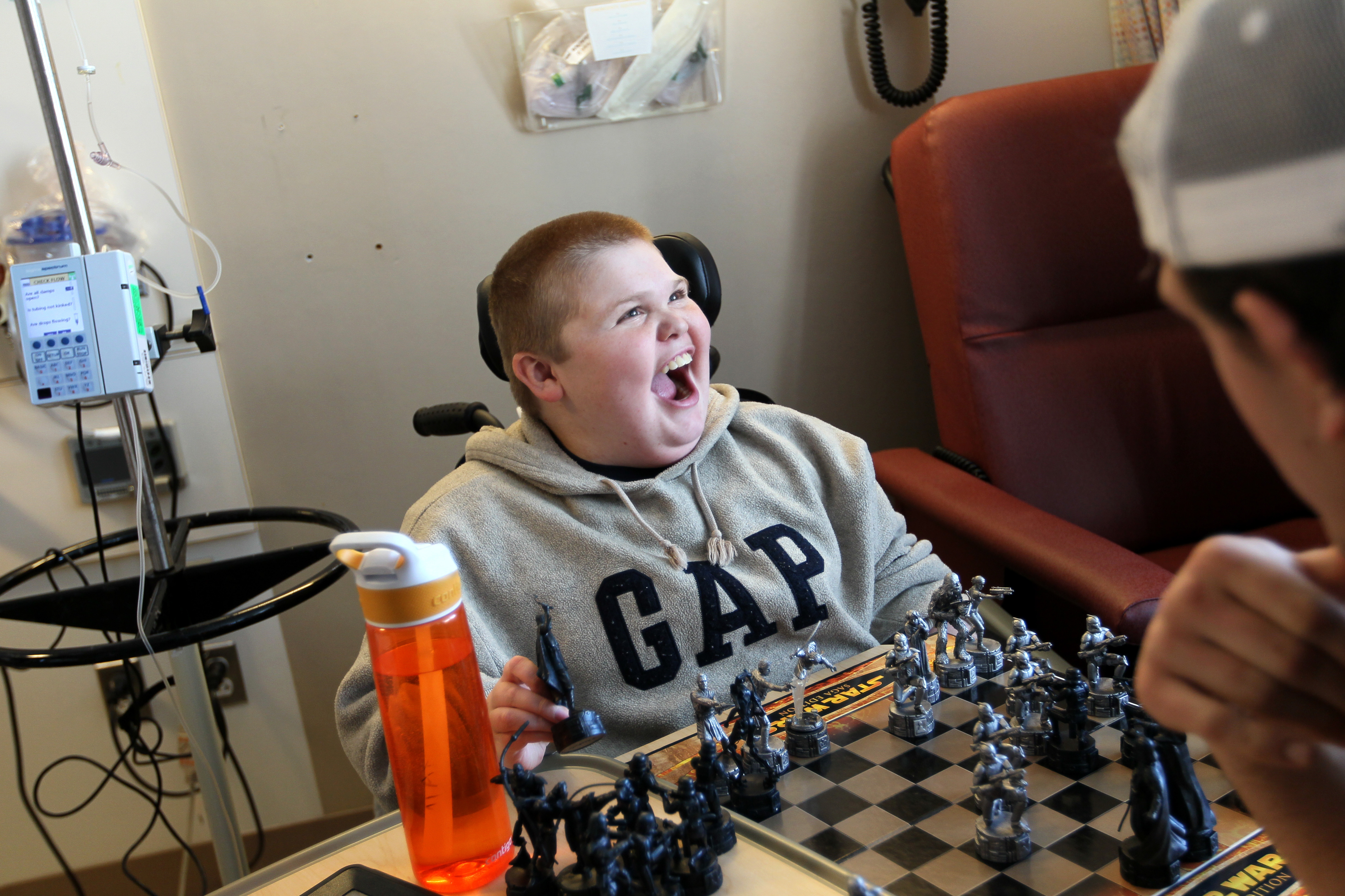 Austin plays chess while receiving an IV earlier this year.