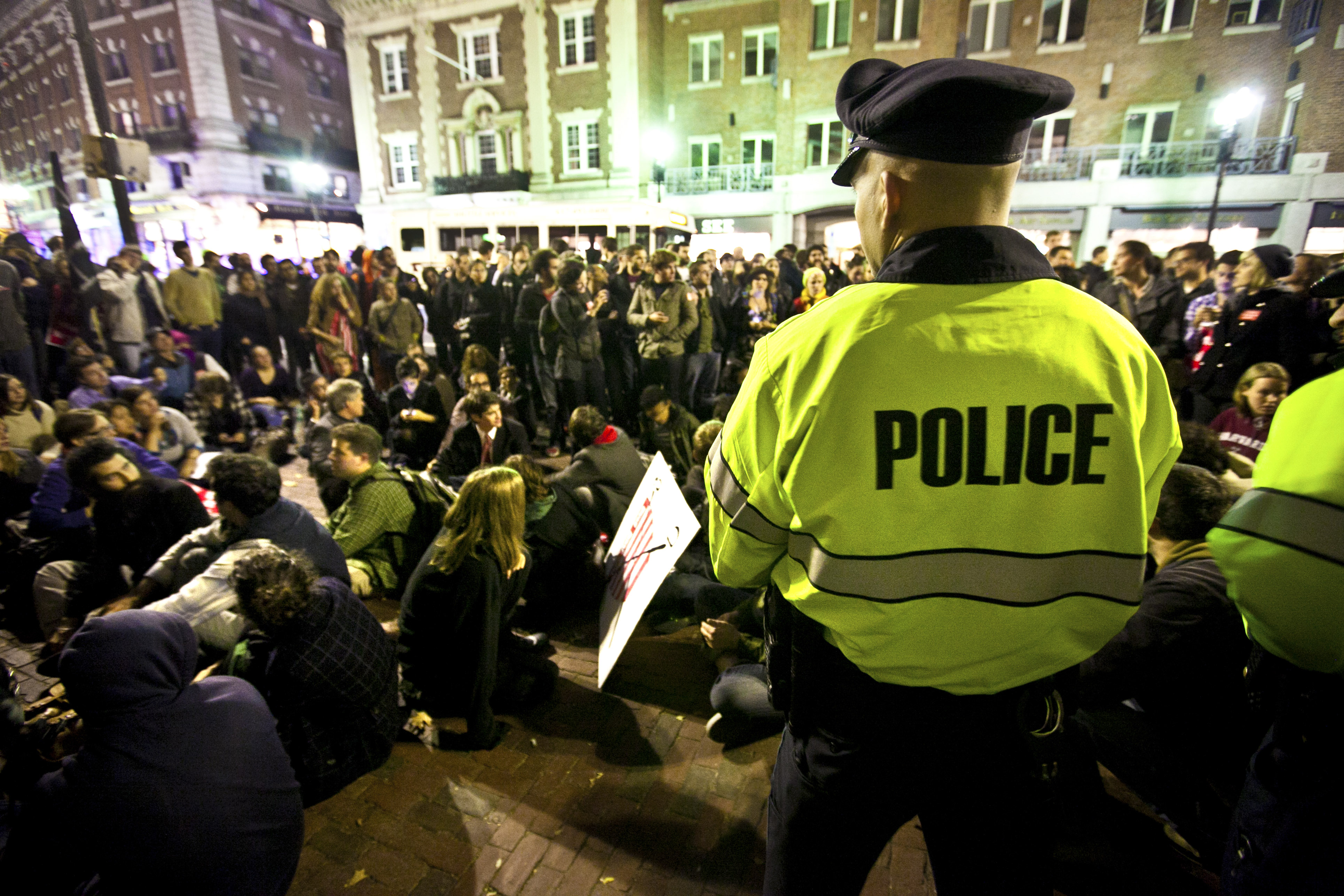 Cambridge Police officers kept watch over group of Occupy protesters outside the gates at Harvard University last night.