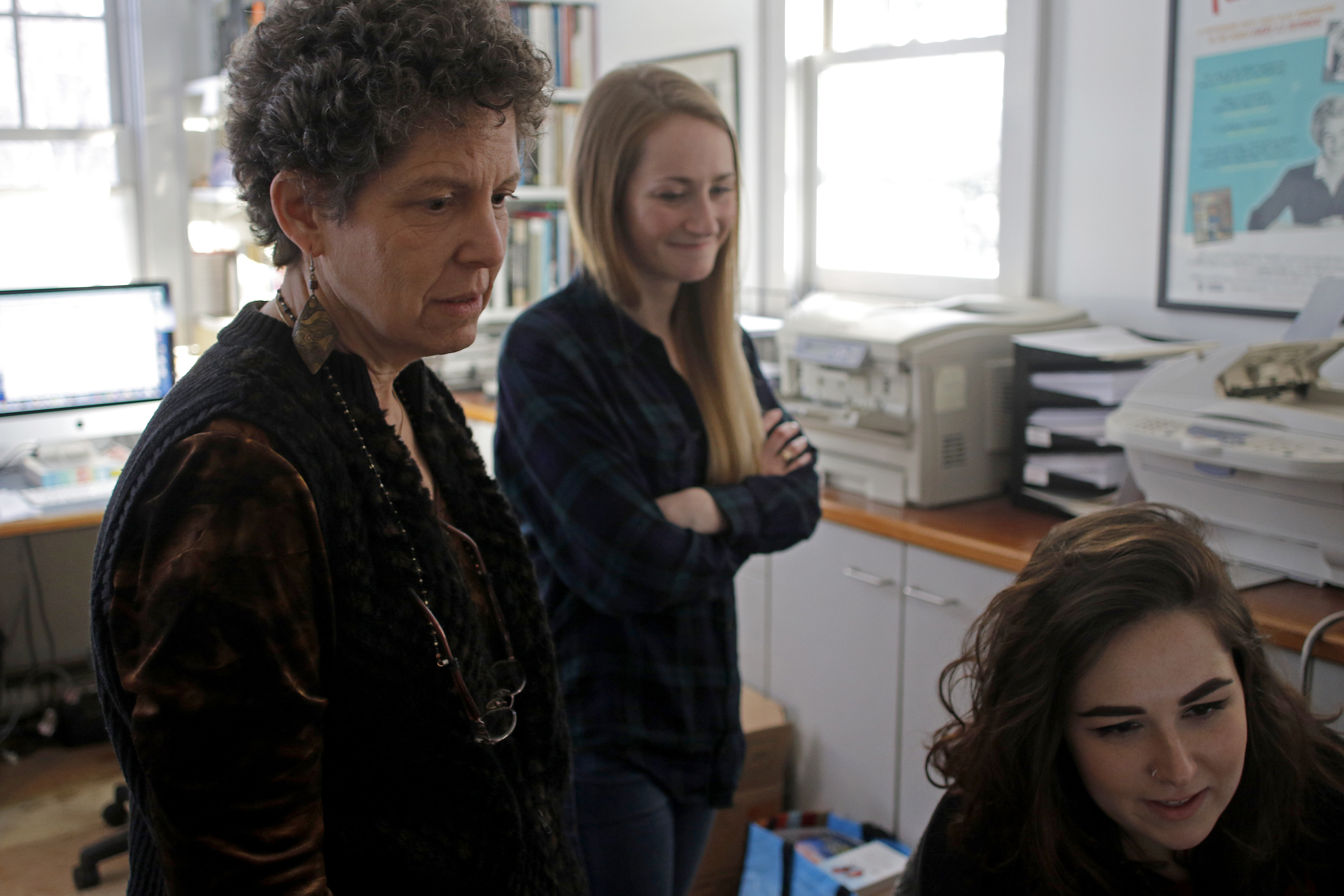 Laurie Kahn (left) looked at pictures with production assistant Riley Davis (center) and production coordinator Julia Hines.