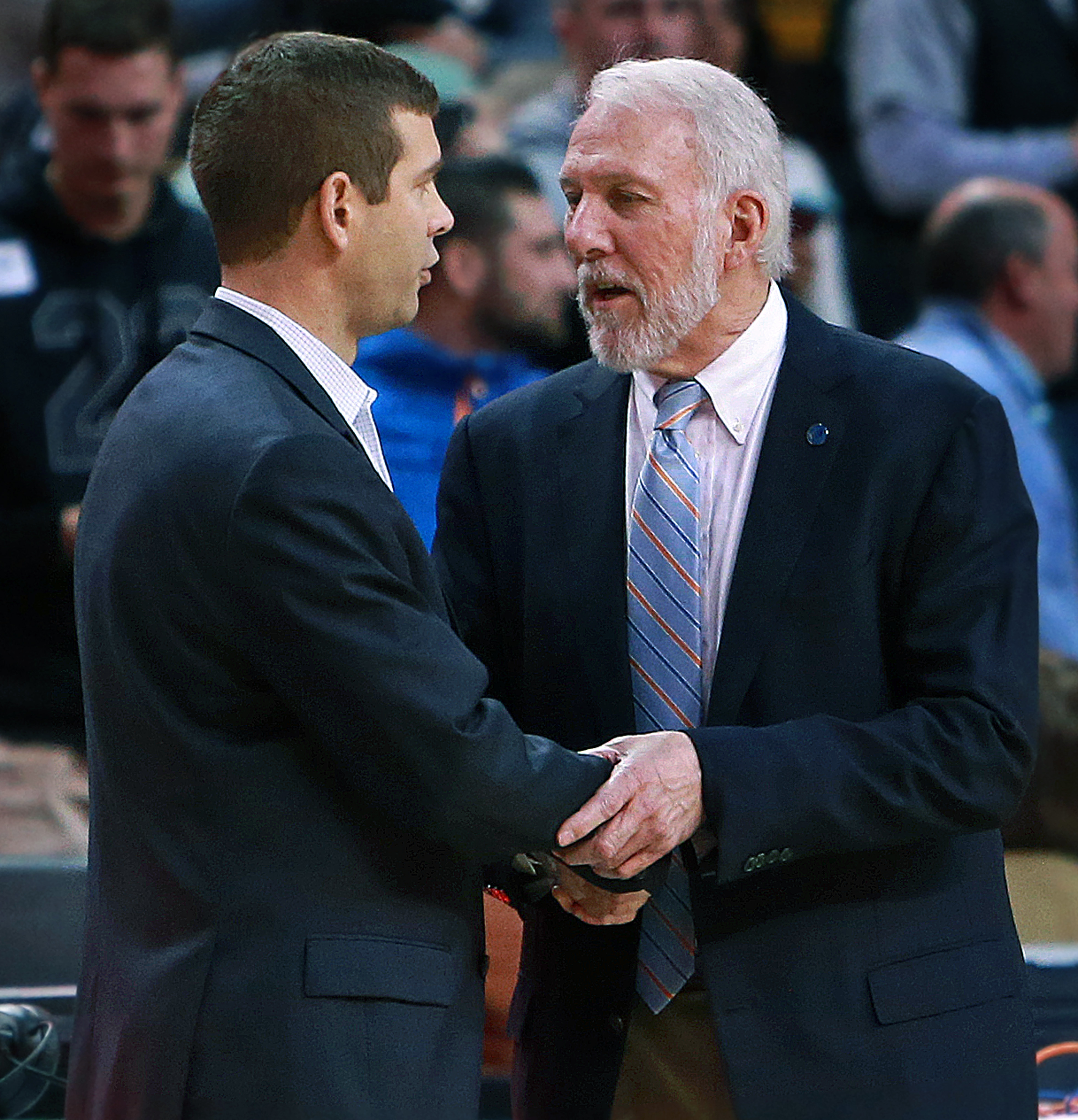 Celtics coach Brad Stevens (left) and Spurs coach Gregg Popovich share a moment after the game ended.