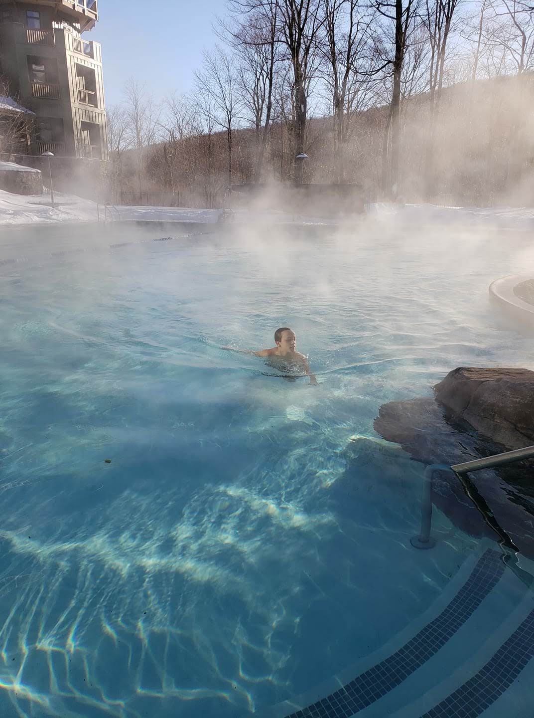 The outdoor heated pool, with two hot tubs, is accessed through the Spa at Spruce Peak.