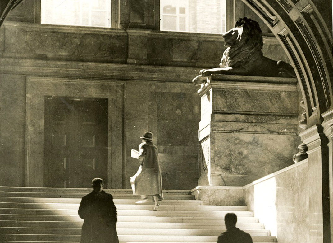 June 13, 1926: The play of light on the marble of the grand staircase lead one up to the twin lions on pedestals at the turn of the stairs. The lions were made from unpolished Siena marble by sculptor Louis Saint-Gaudens. They are memorials to the Second and Twentieth Massachusetts Civil War infantry regiments.