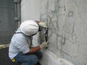 A worker took measurements on the exterior of the Service Water building at the Seabrook Nuclear Power Plant.