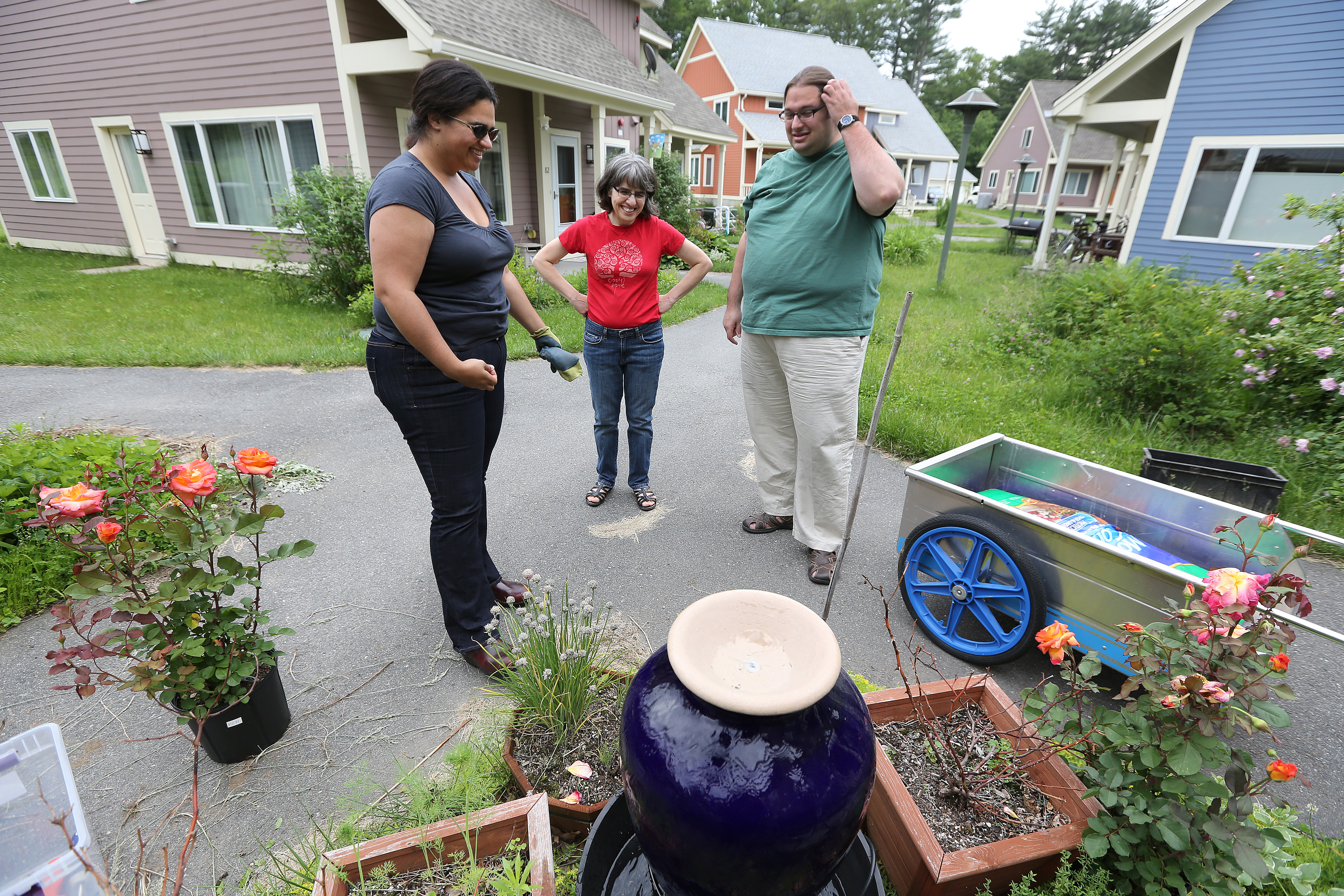 Charlene DiCalogero, center, confers with neighbors at Camelot CoHousing, a development engineered to encourage friendship and community involvement.