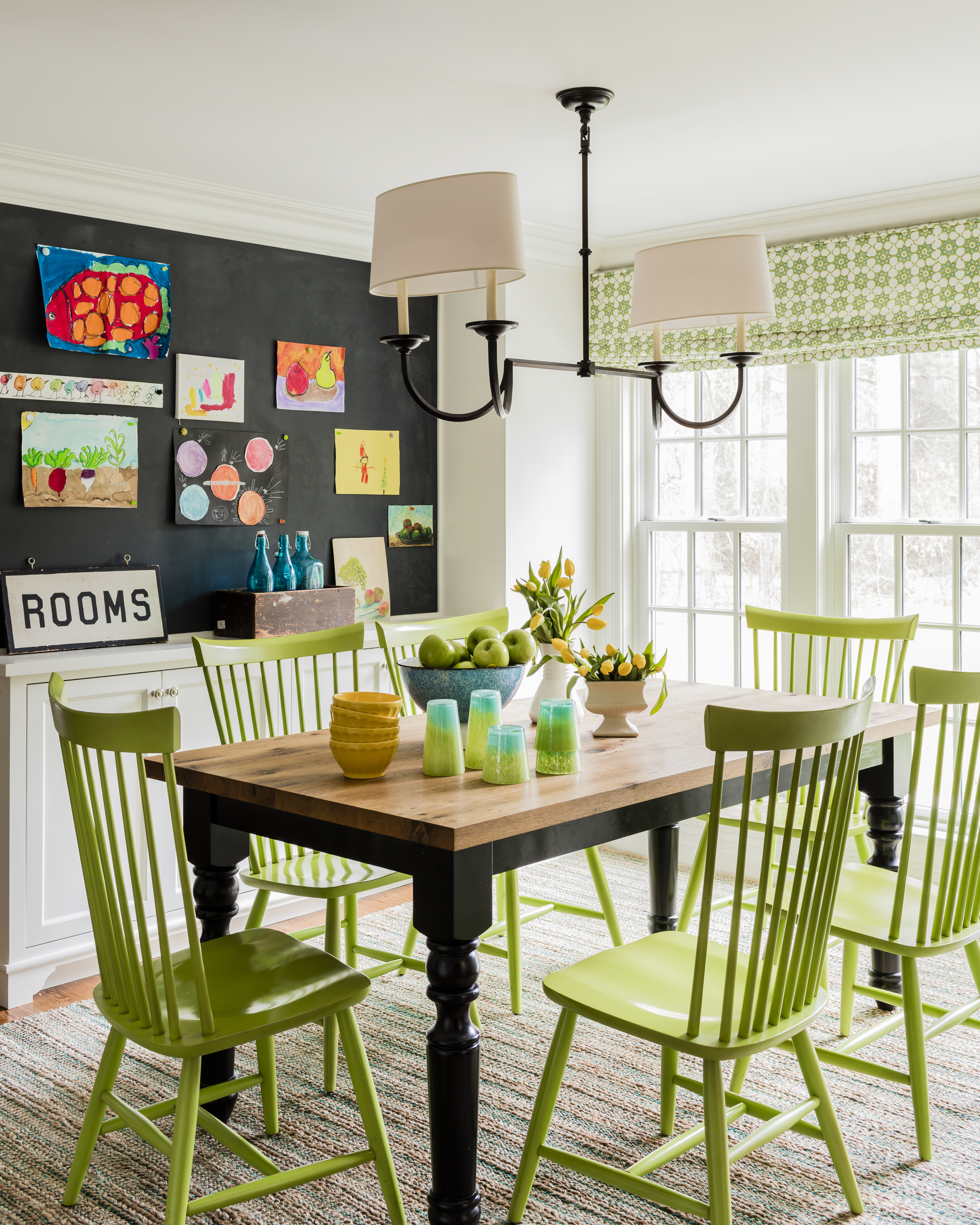 A sisal Crate & Barrel rug conceals spills. The oil-rubbed bronze chandelier by Visual Comfort has a timeworn appeal.