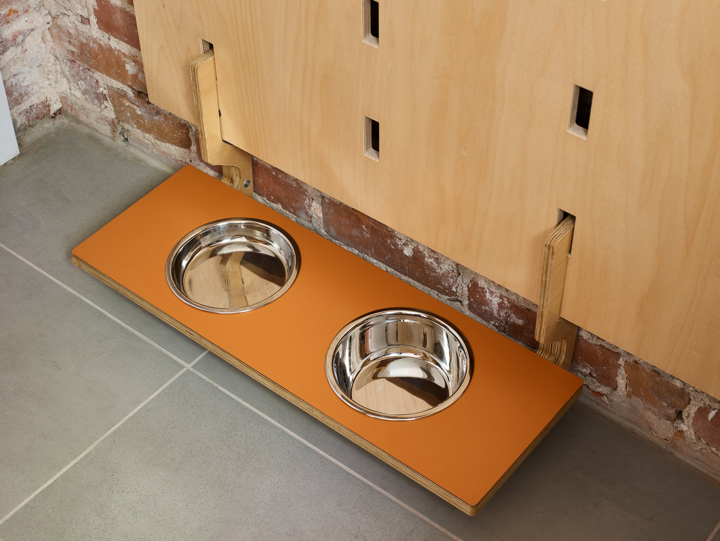 Gimlet’s feeding shelf hangs from custom hooks at the bottom of the Kerf Wall.