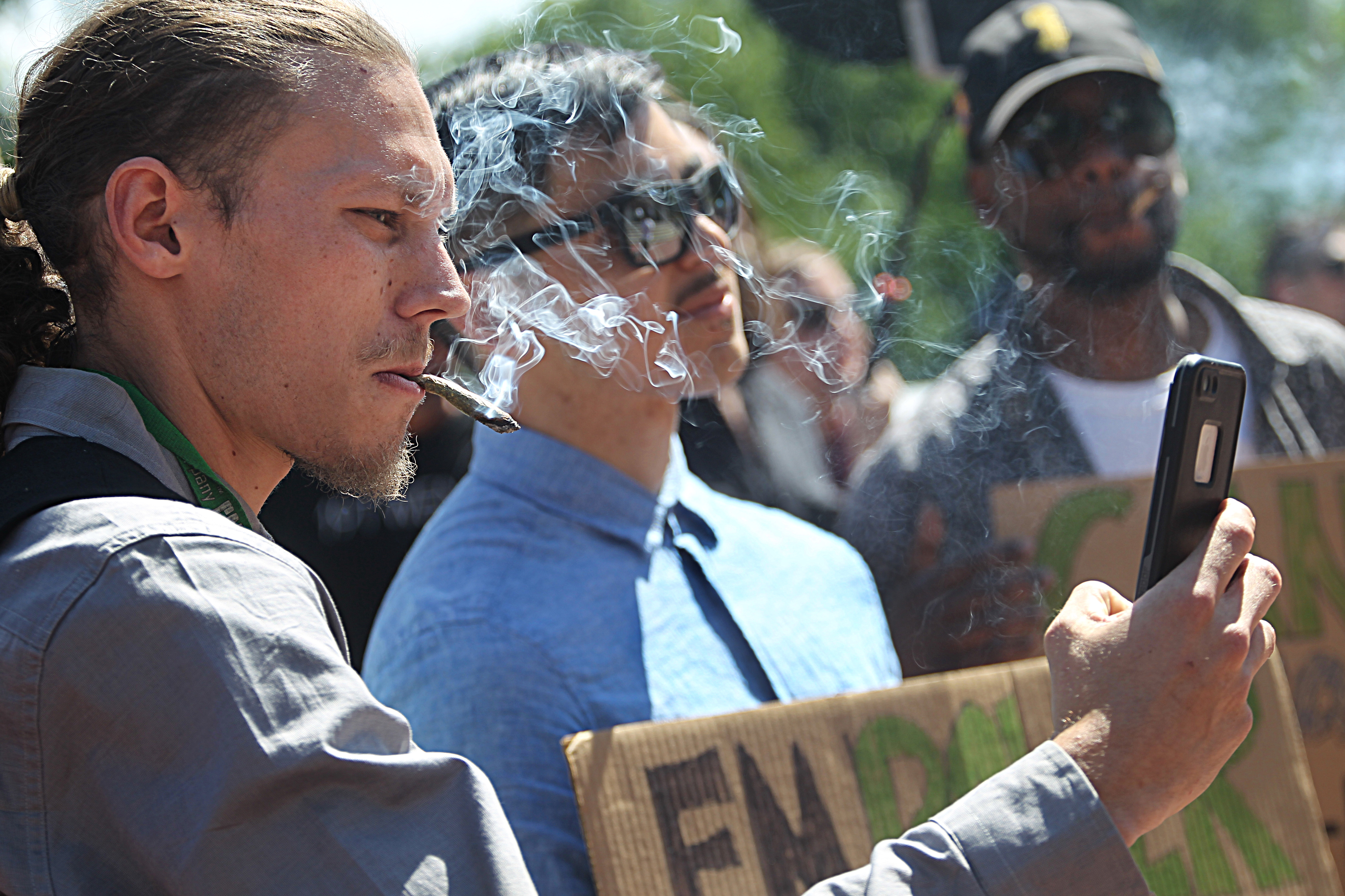 Cannabis activists, including Jesse Daniels (left), and supporters smoked marijuana in front of the Massachusetts State House on Wednesday.