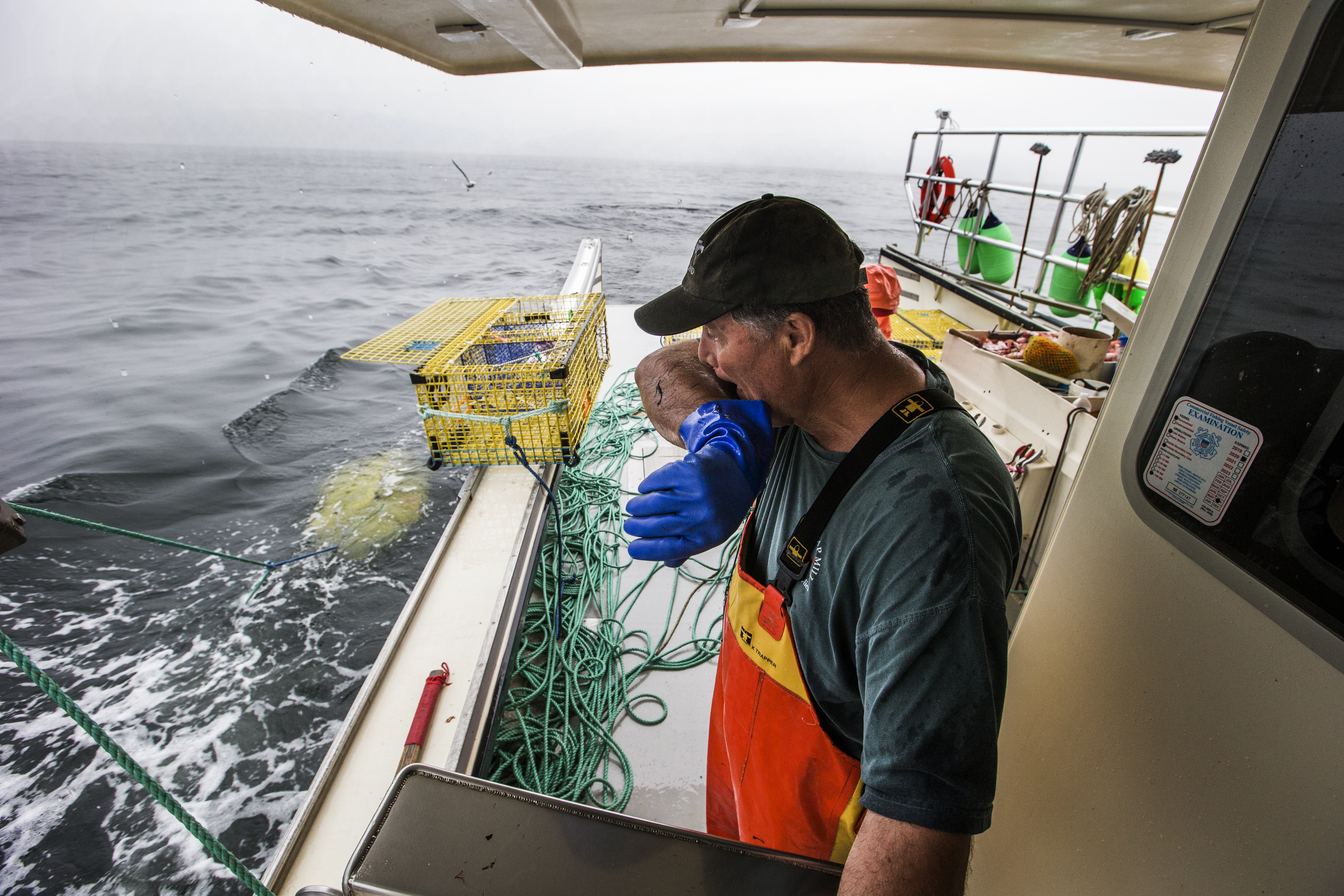John Farrell wipes away the rain from his face during a 12 hour lobster run.