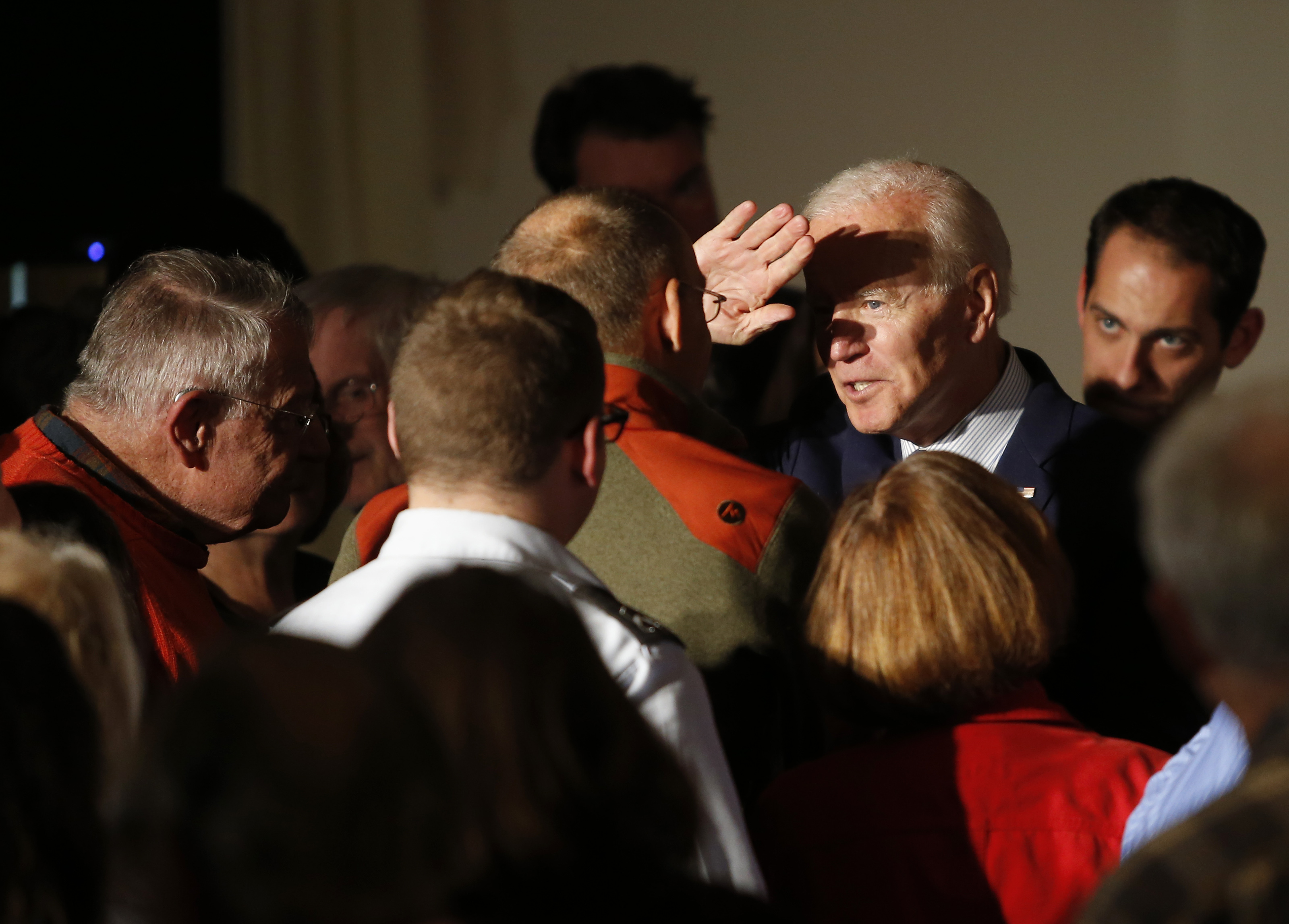 Biden raised his hand to shield his eyes from bright lights in Rochester.