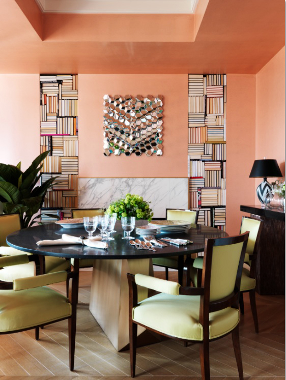Geometrically patterned books are stacked in columns in this House Beautiful showroom apartment.