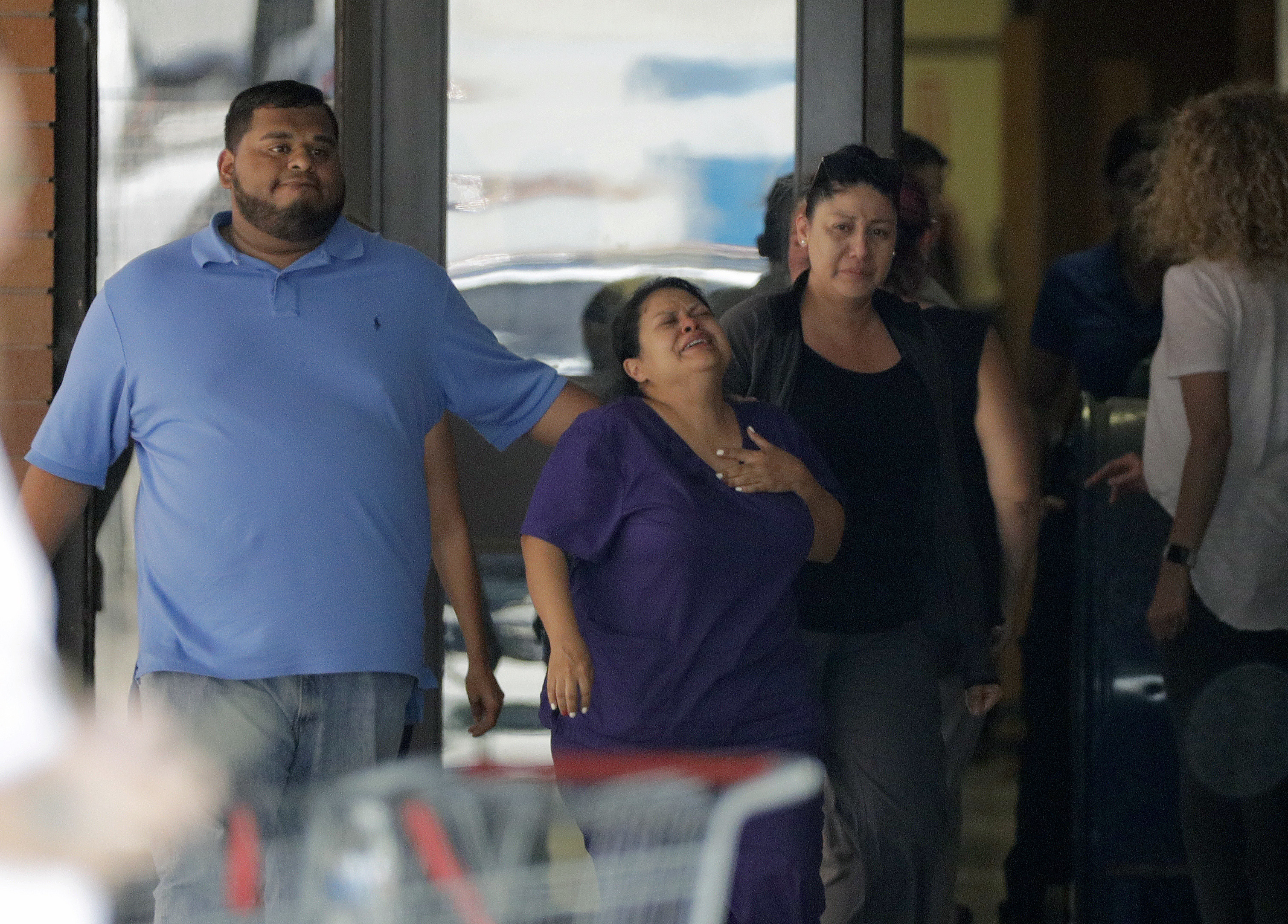 People reacted as they left the family unification center at the Alamo Gym, following a shooting at Santa Fe High School.