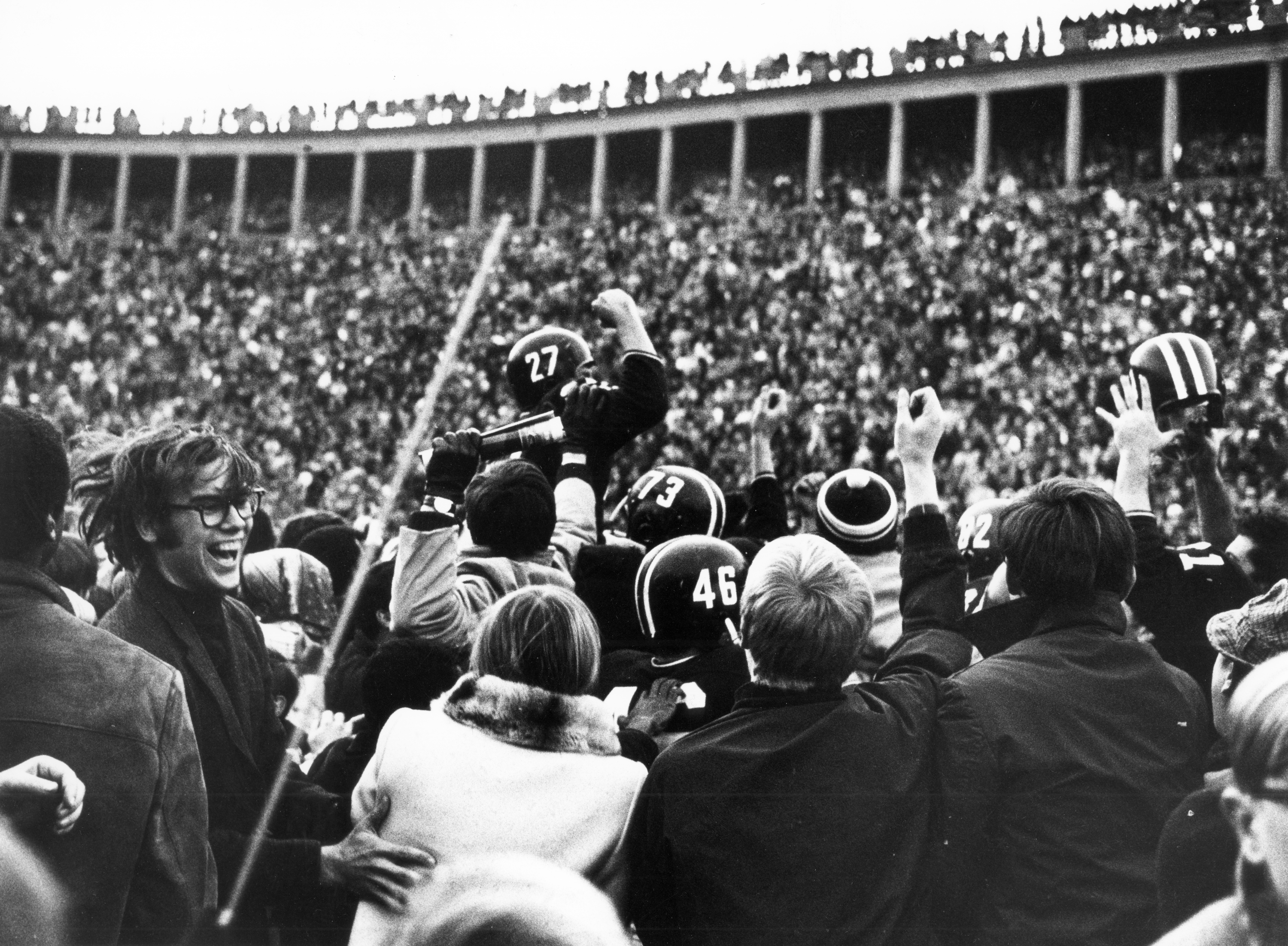 Harvard quarterback Frank Champi is carried off after the game.
