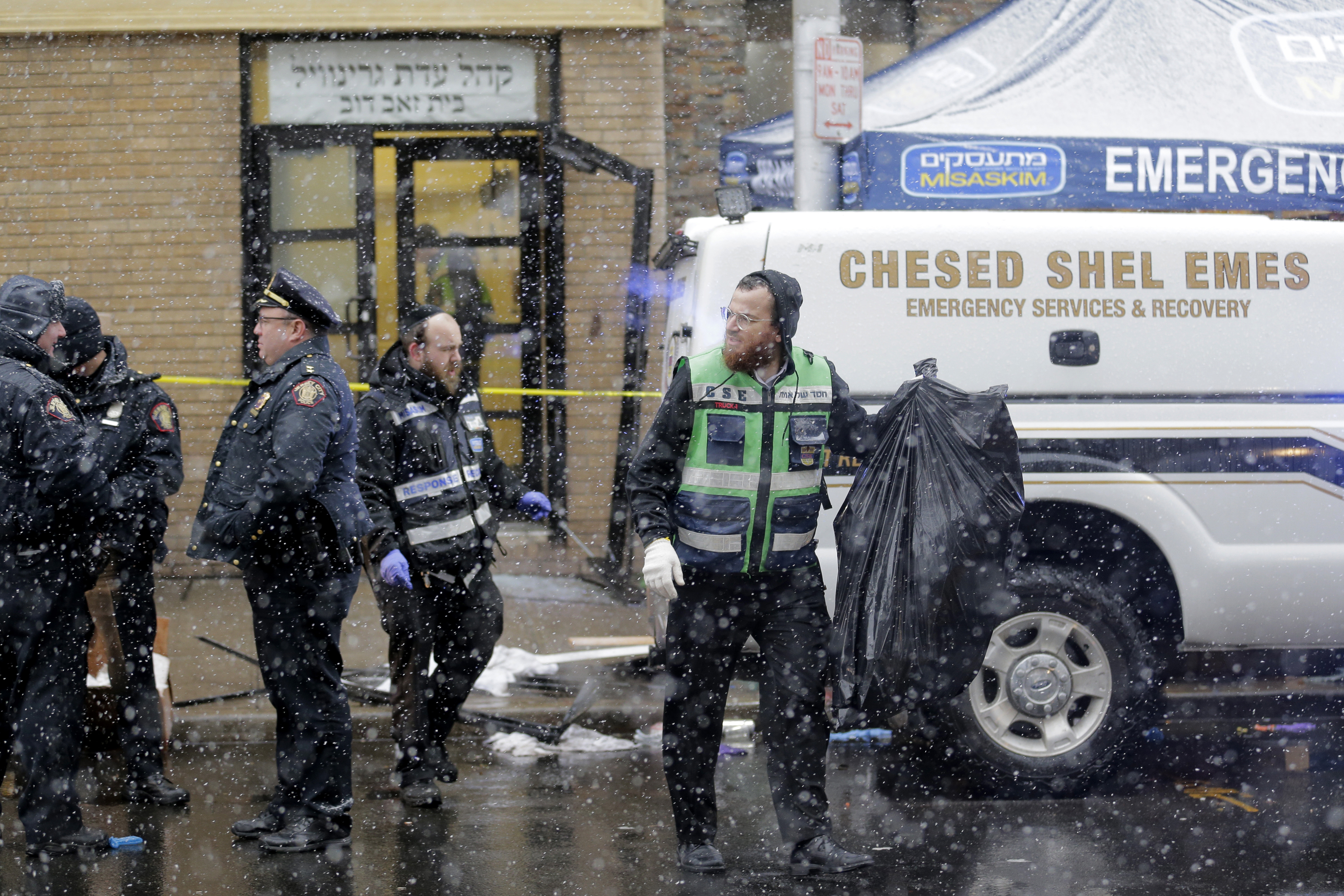Emergency responders work near a kosher supermarket and a synagogue near the site of shooting in Jersey City, N.J., Wednesday, Dec. 11, 2019. The mayor of a New Jersey city says gunmen targeted the kosher market during a shooting that killed multiple people Tuesday. (AP Photo/Seth Wenig)