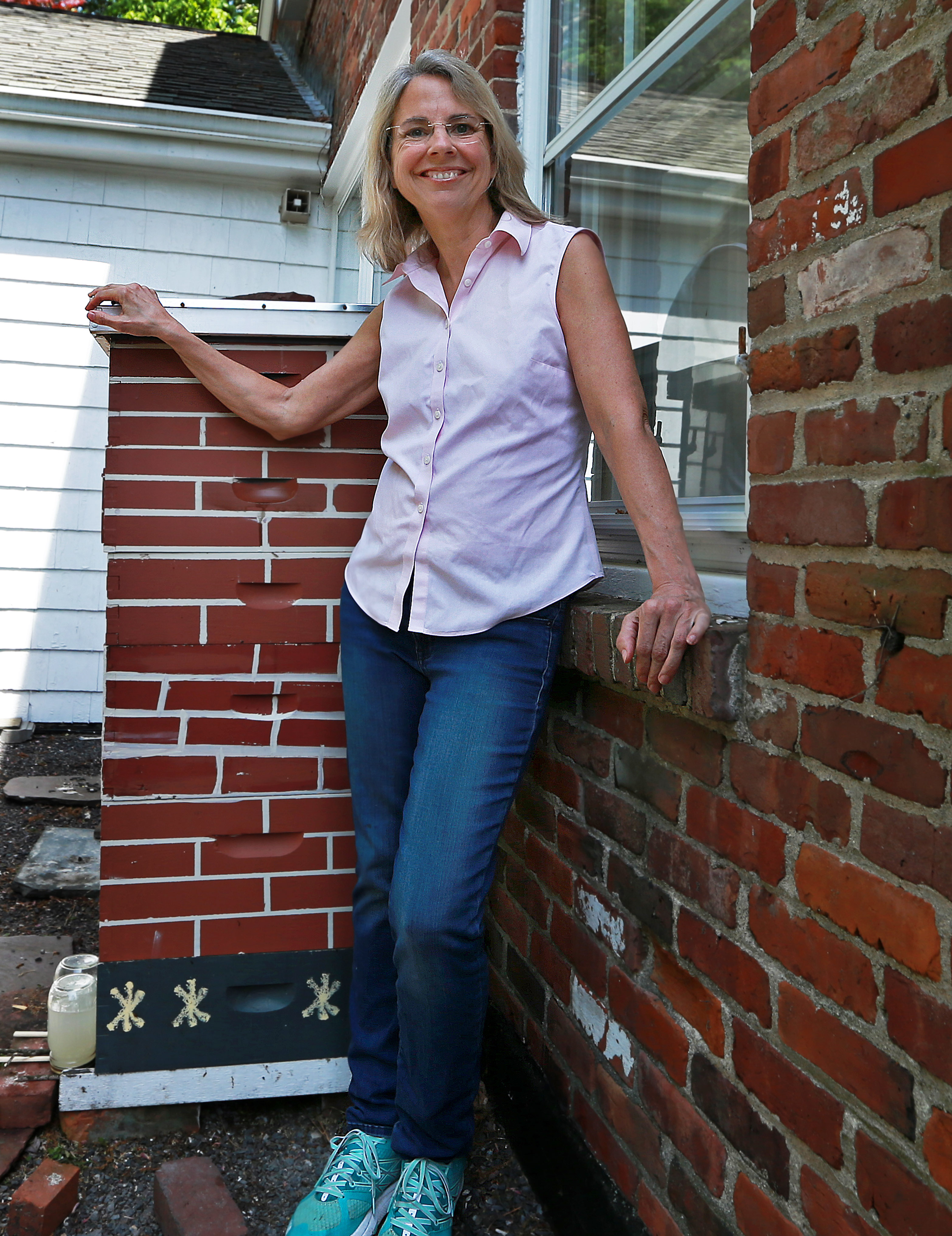 Alexandra Bartsch, the swarm coordinator for the Middlesex County Beekeepers Association, near a hive outside of her home.