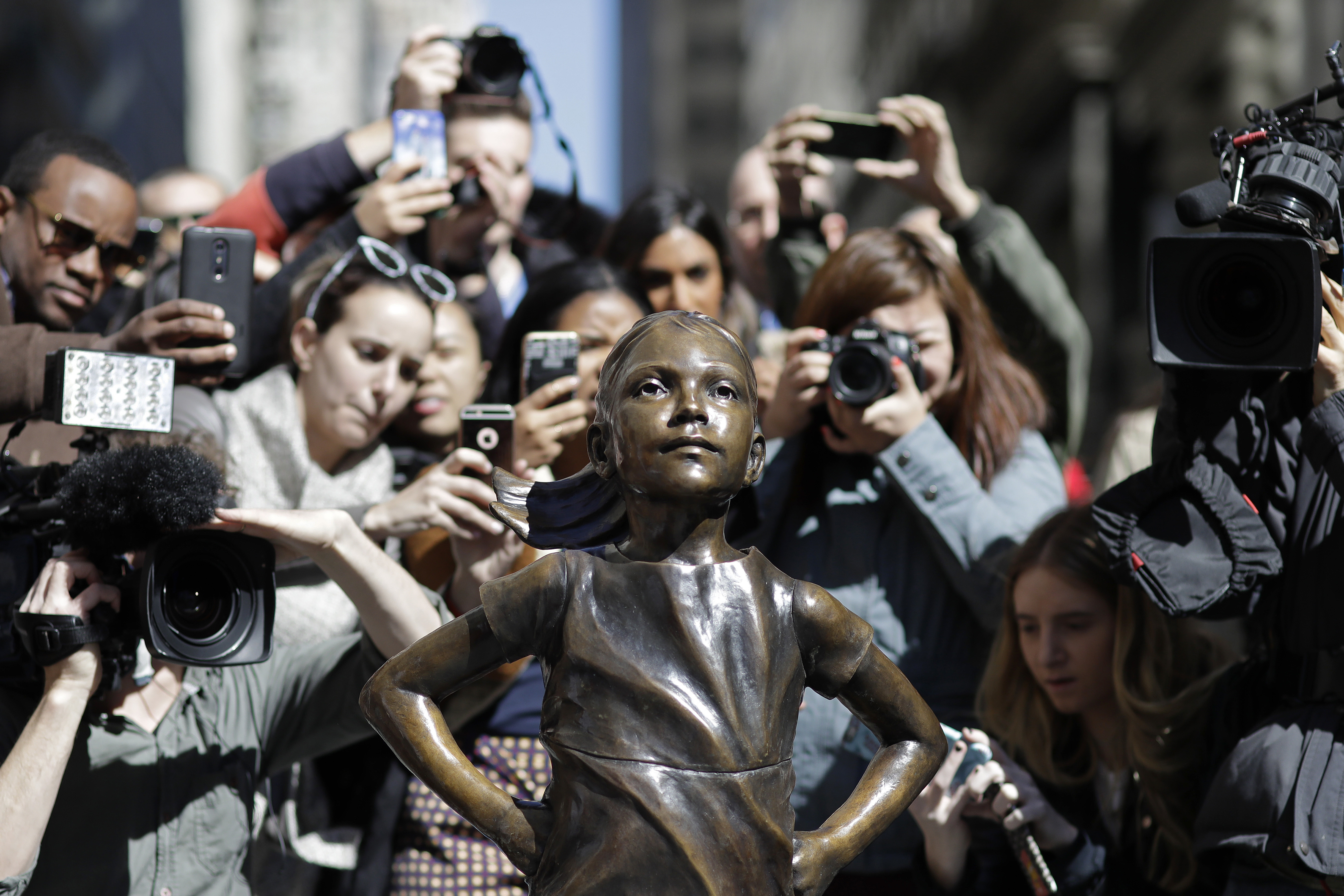 People stopped to photograph the “Fearless Girl” statue on Wednesday.