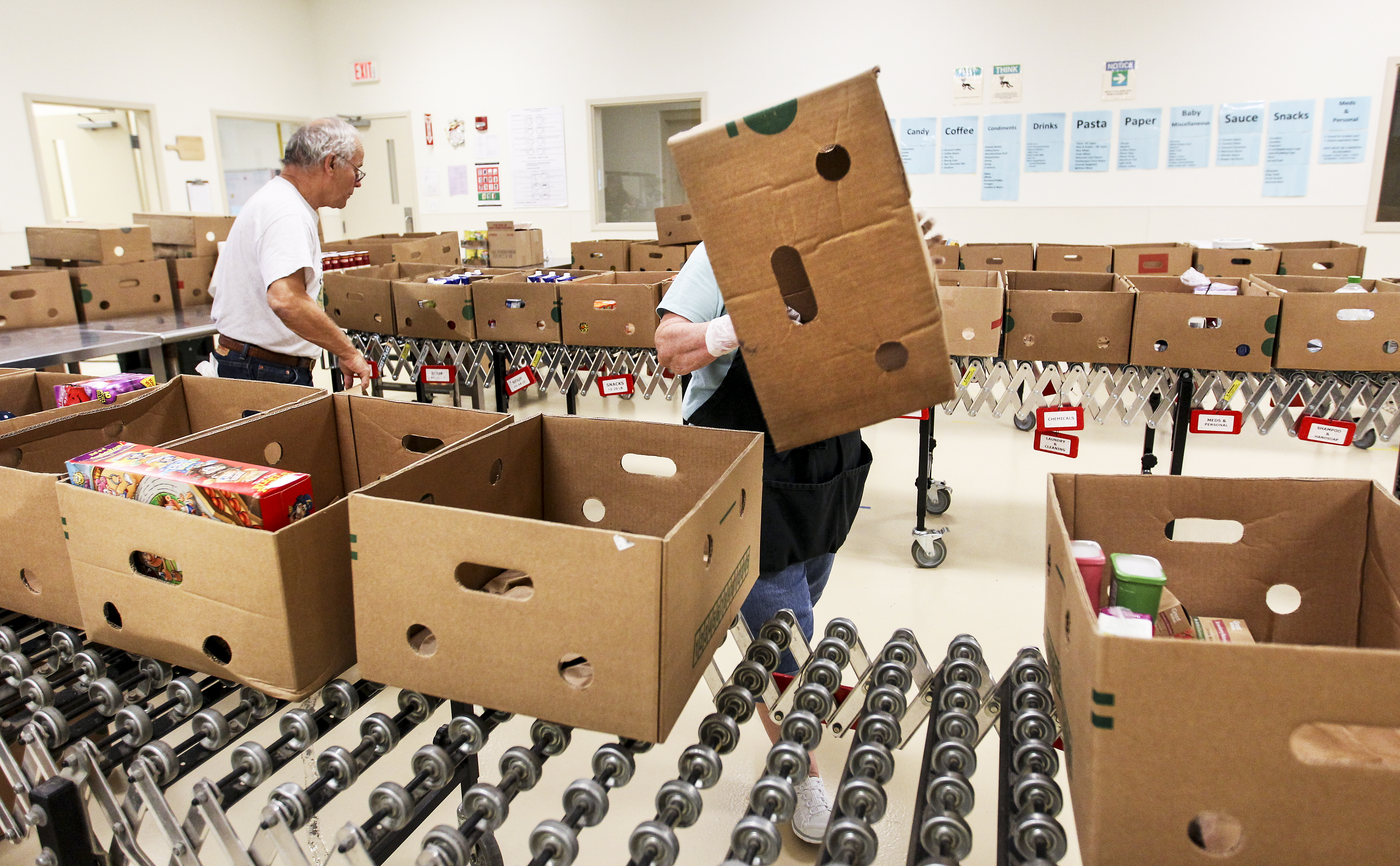 Workers sorted boxes and processed packages of frozen meat.