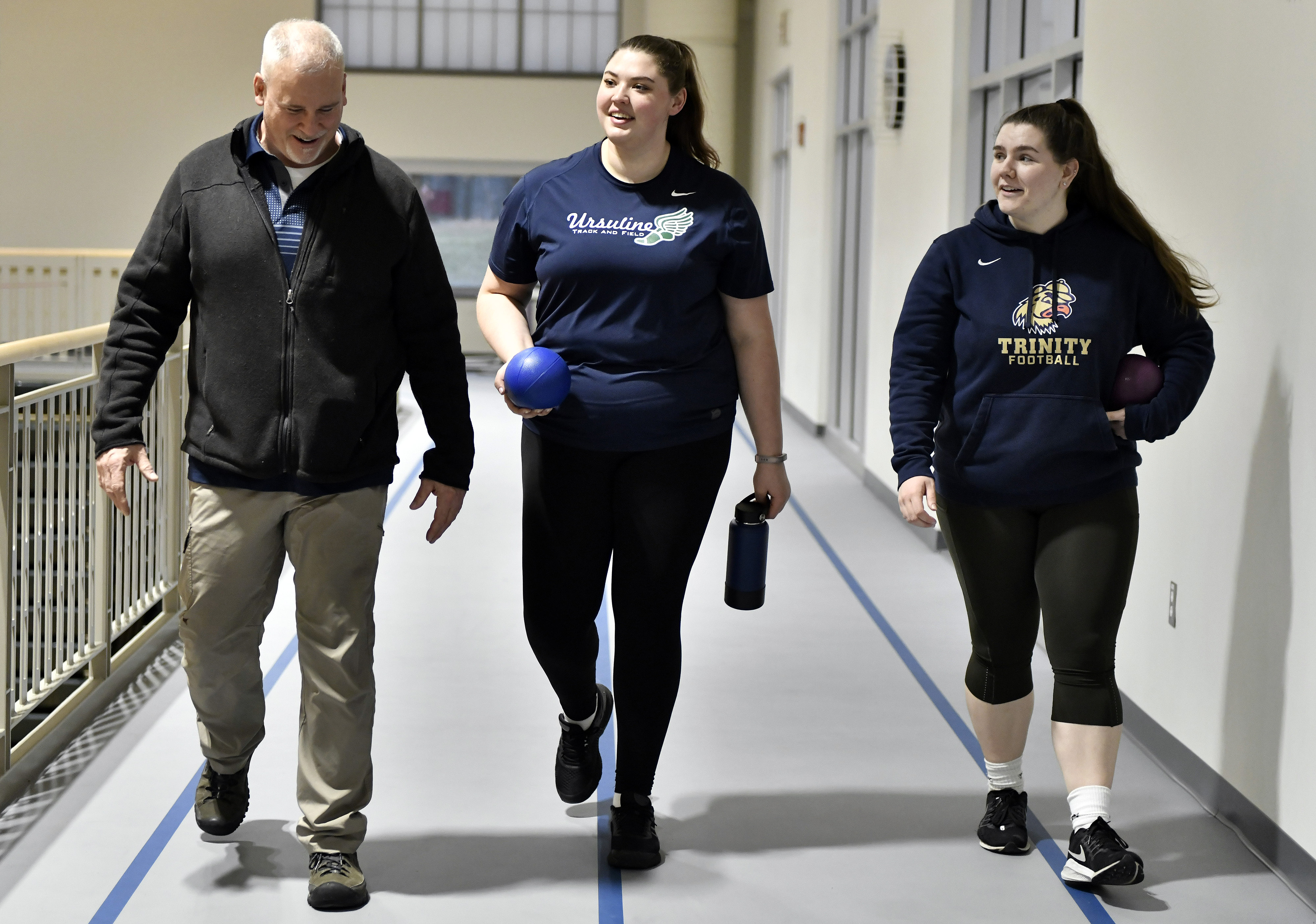 Siobhan O'Sullivan (center) with coach Kevin Enos (left) and teammate Anna Crowley. O'Sullivan is the No. 1 seed in the EMass Division 5 track & field meet on Feb. 16.