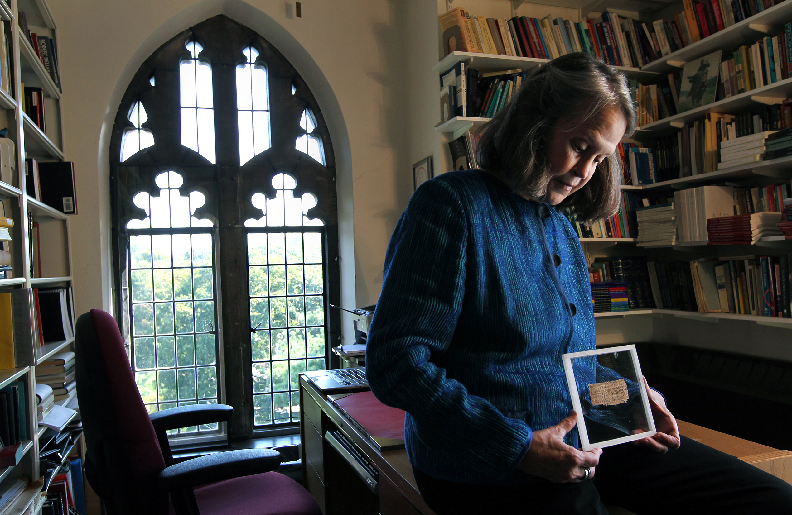 Karen L. King in her Harvard University office with a papyrus fragment she named “The Gospel of Jesus’s Wife.”