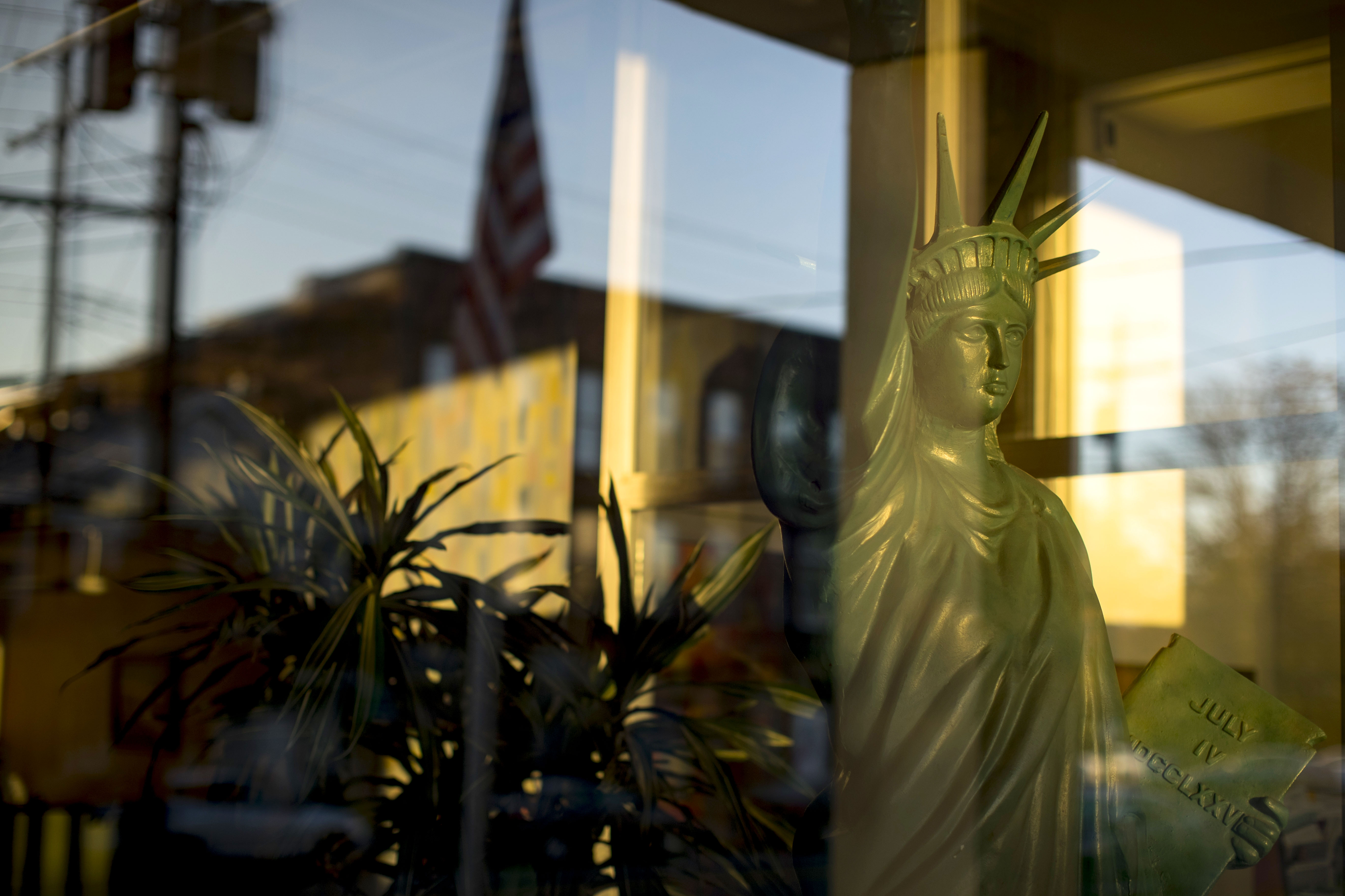 An American flag reflected in a window of the American Civic Association.