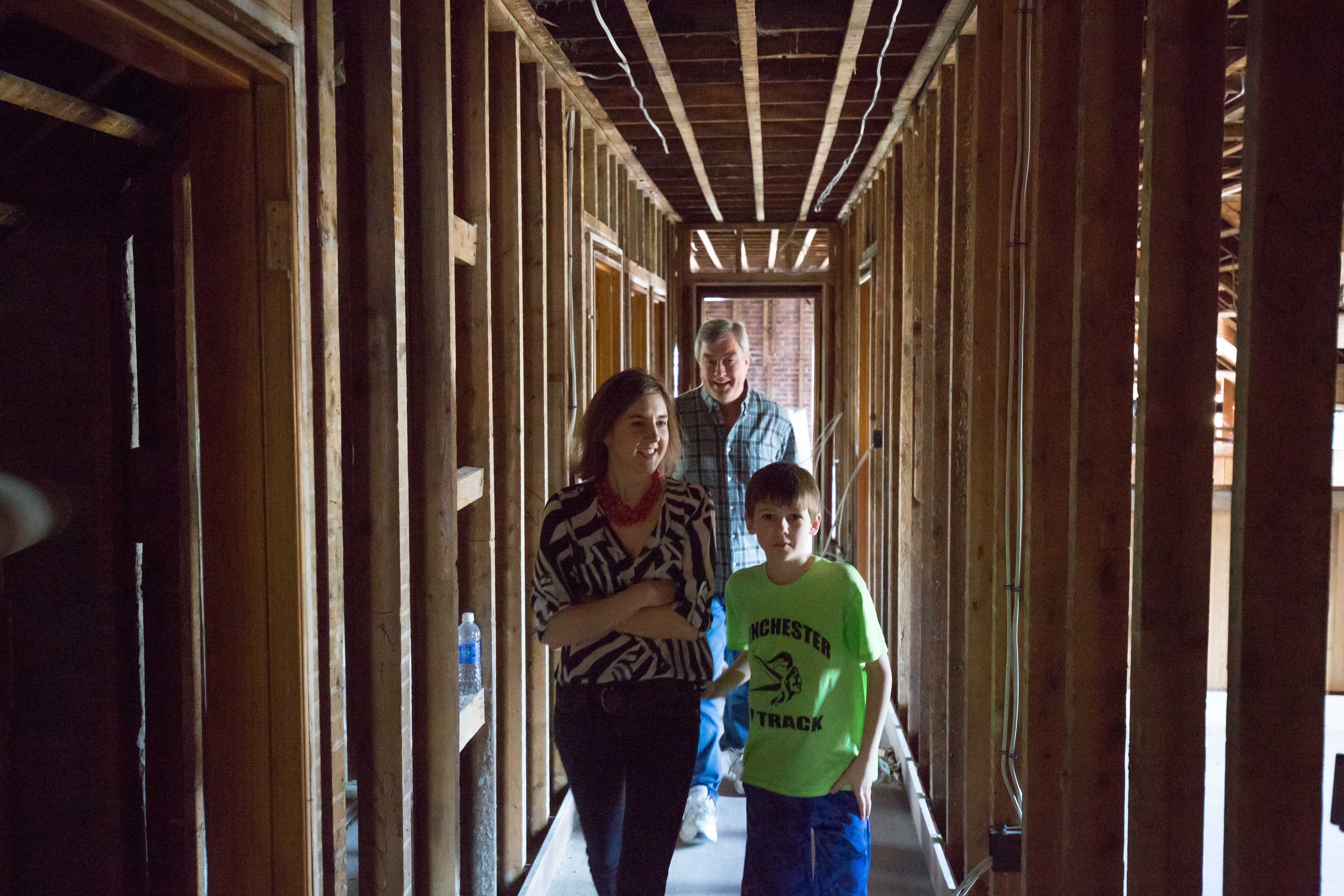 Jennifer Adams, her son Bennett, and Winchester Historical Commission member Jack LeMenager tour a 1914 house under renovation at 7 Grove St.