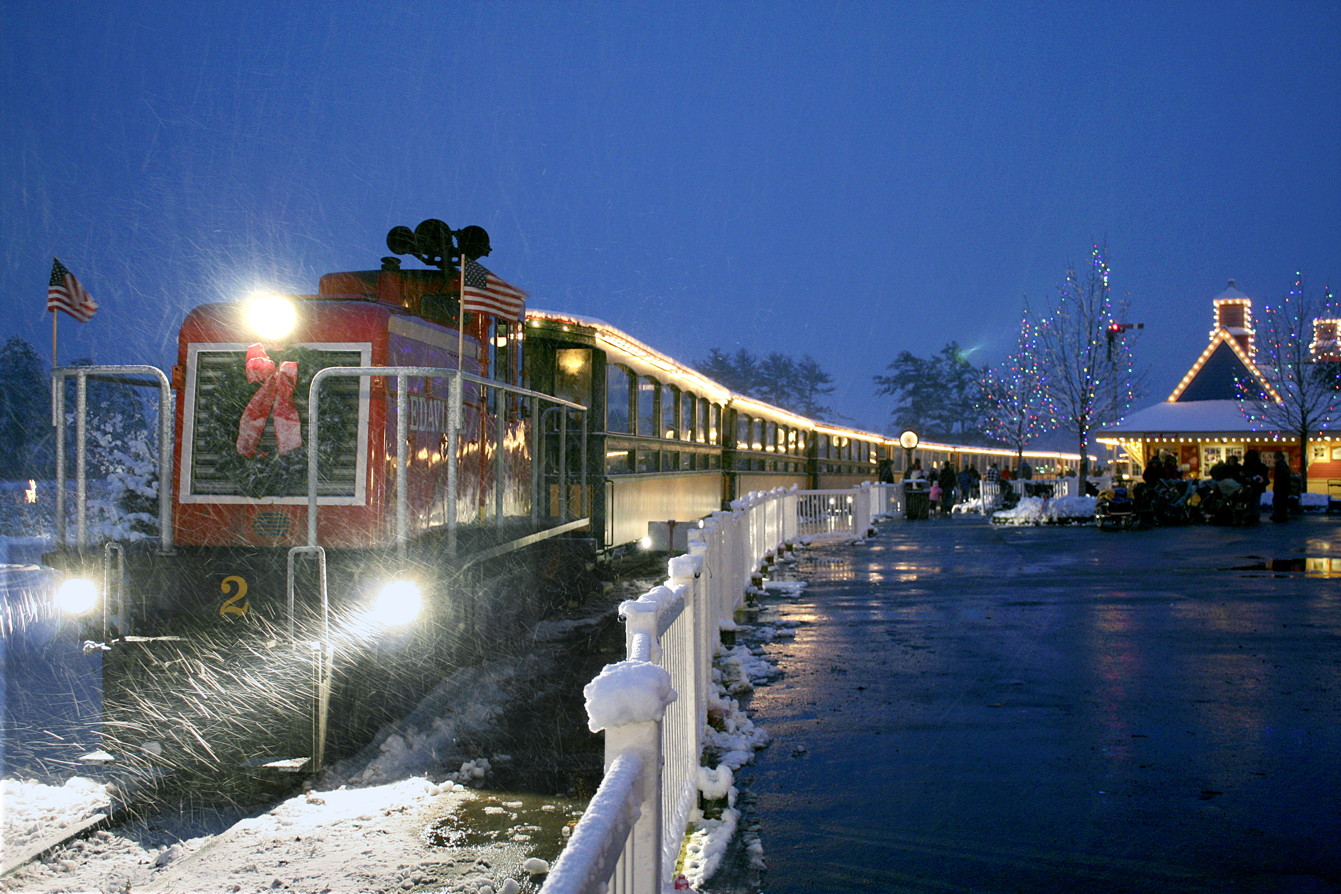 The Edaville train in snow during christmas lights festival.