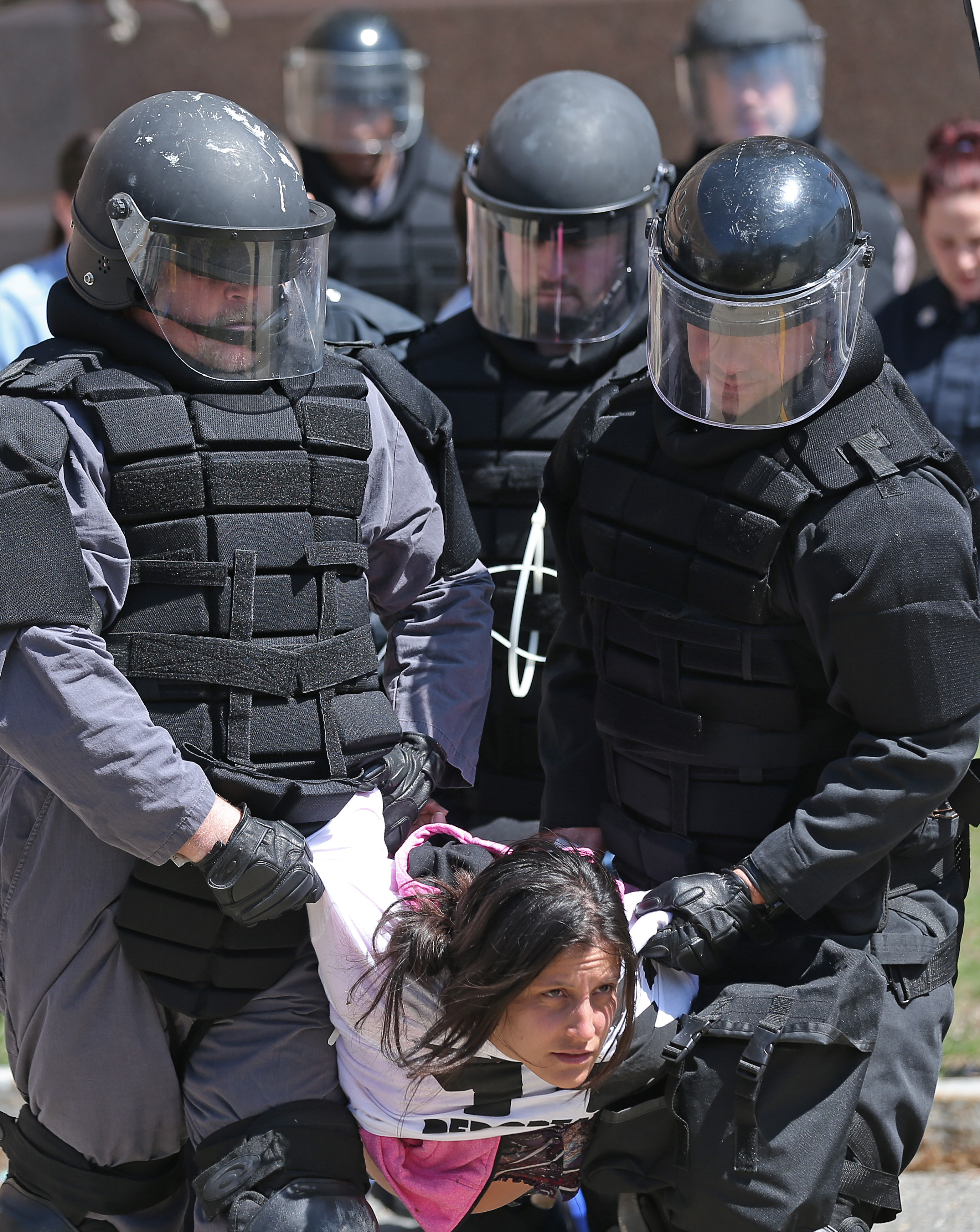 Police arrested 19 activists who blocked the entrance to the Suffolk County House of Correction to protest the deportation of immigrants charged with minor offenses.